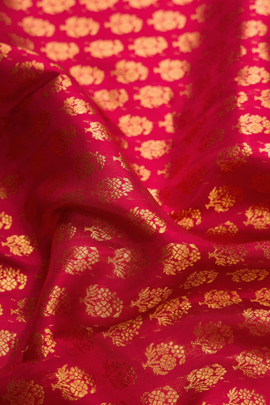 Close up of Red Dual Tone Kanchipuram Silk Saree with Zari Brocade on the body and Zari Border.  displaying folds