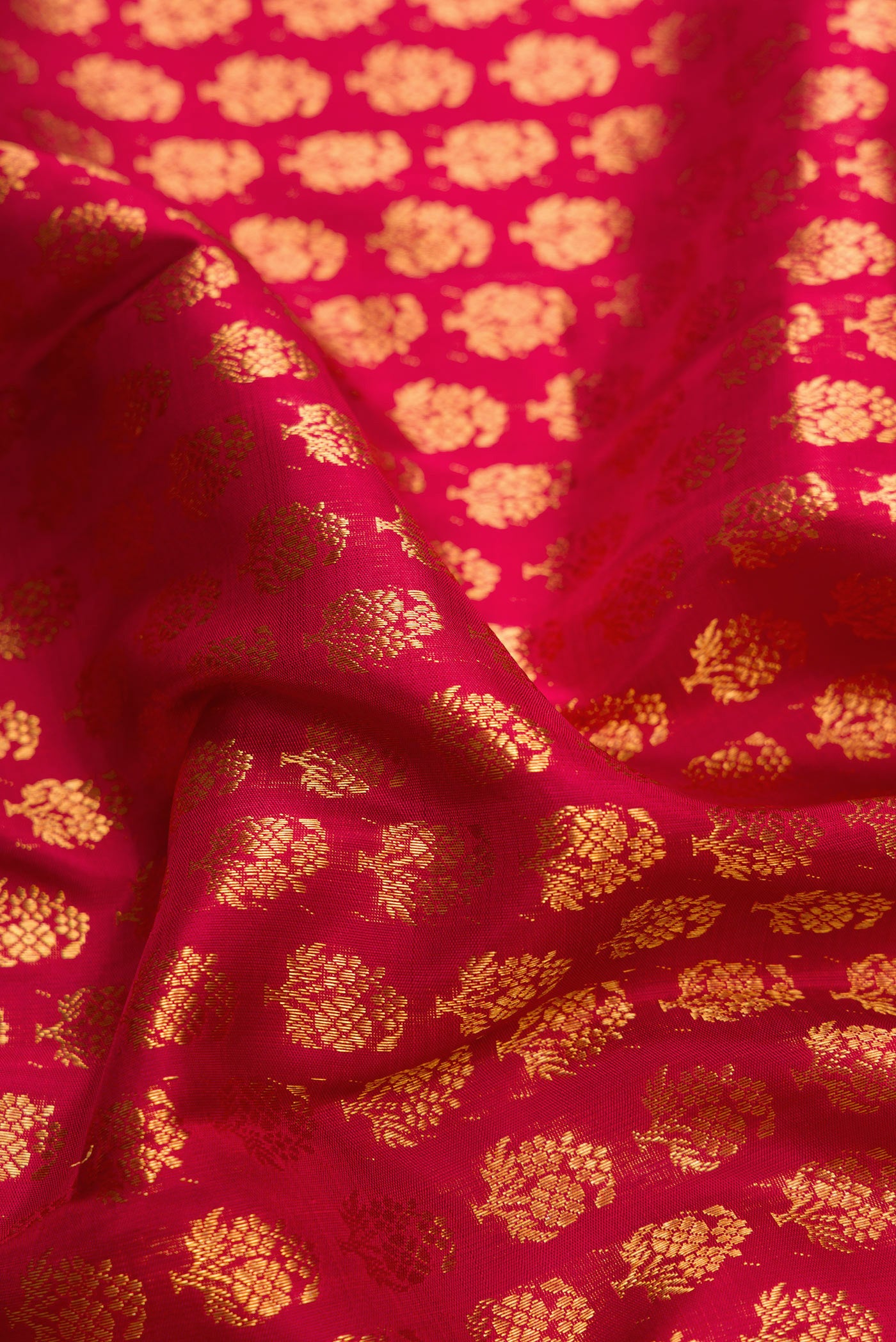 Close up of Red Dual Tone Kanchipuram Silk Saree with Zari Brocade on the body and Zari Border.  displaying folds