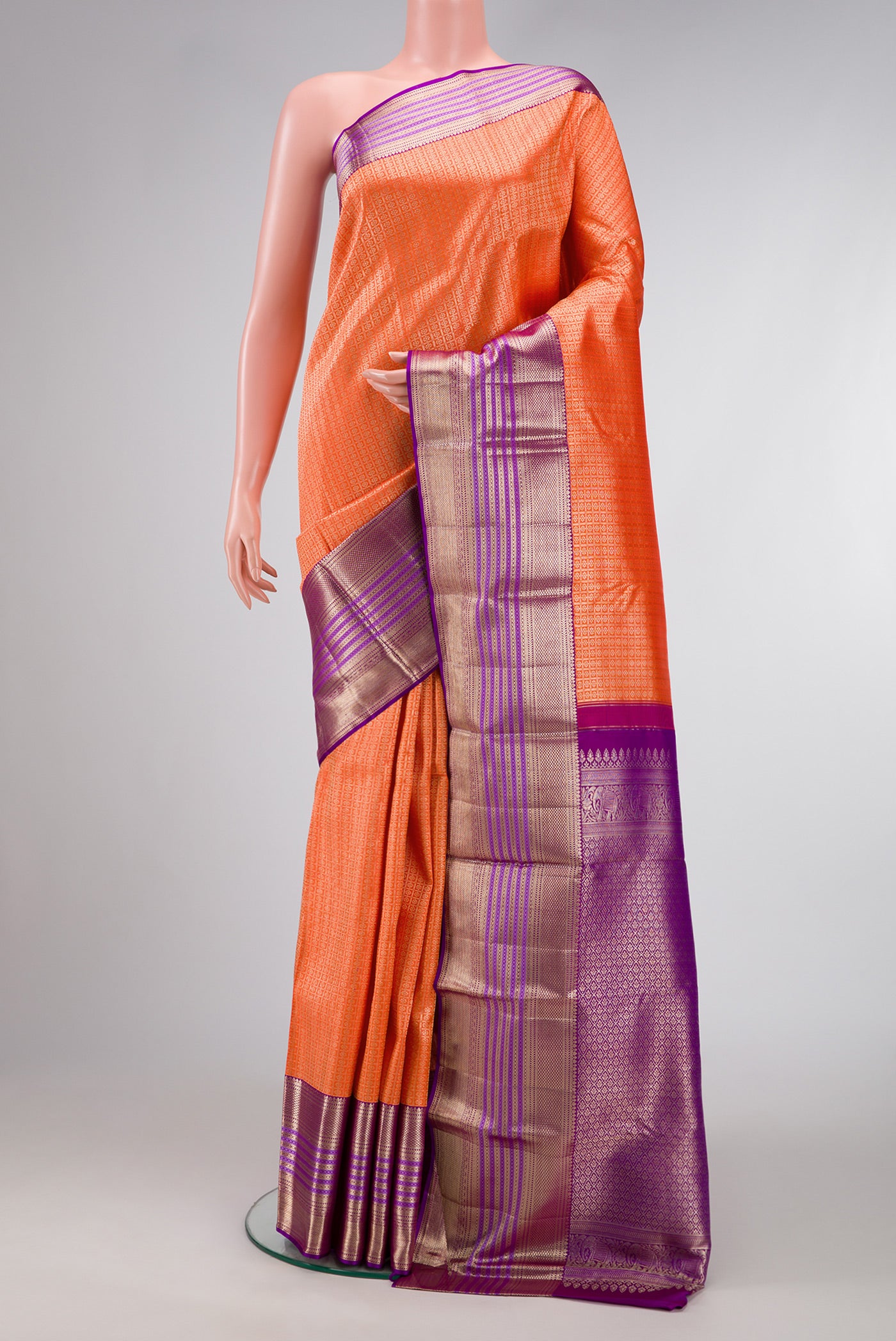 Brick Orange Dual Tone Kanchipuram Silk Saree with Zari Brocade on the body and Zari Border.  displayed on a mannequin