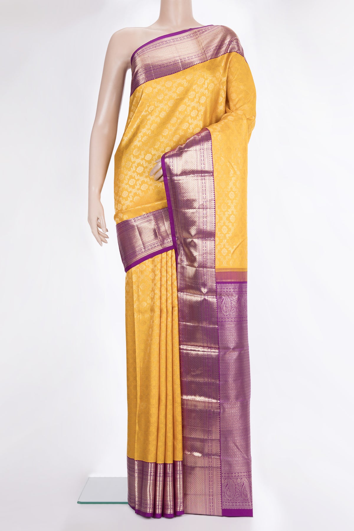 Pure Silk Yellow Kanchipuram Saree with Zari Brocade on the body and Zari Border.  displayed on a mannequin