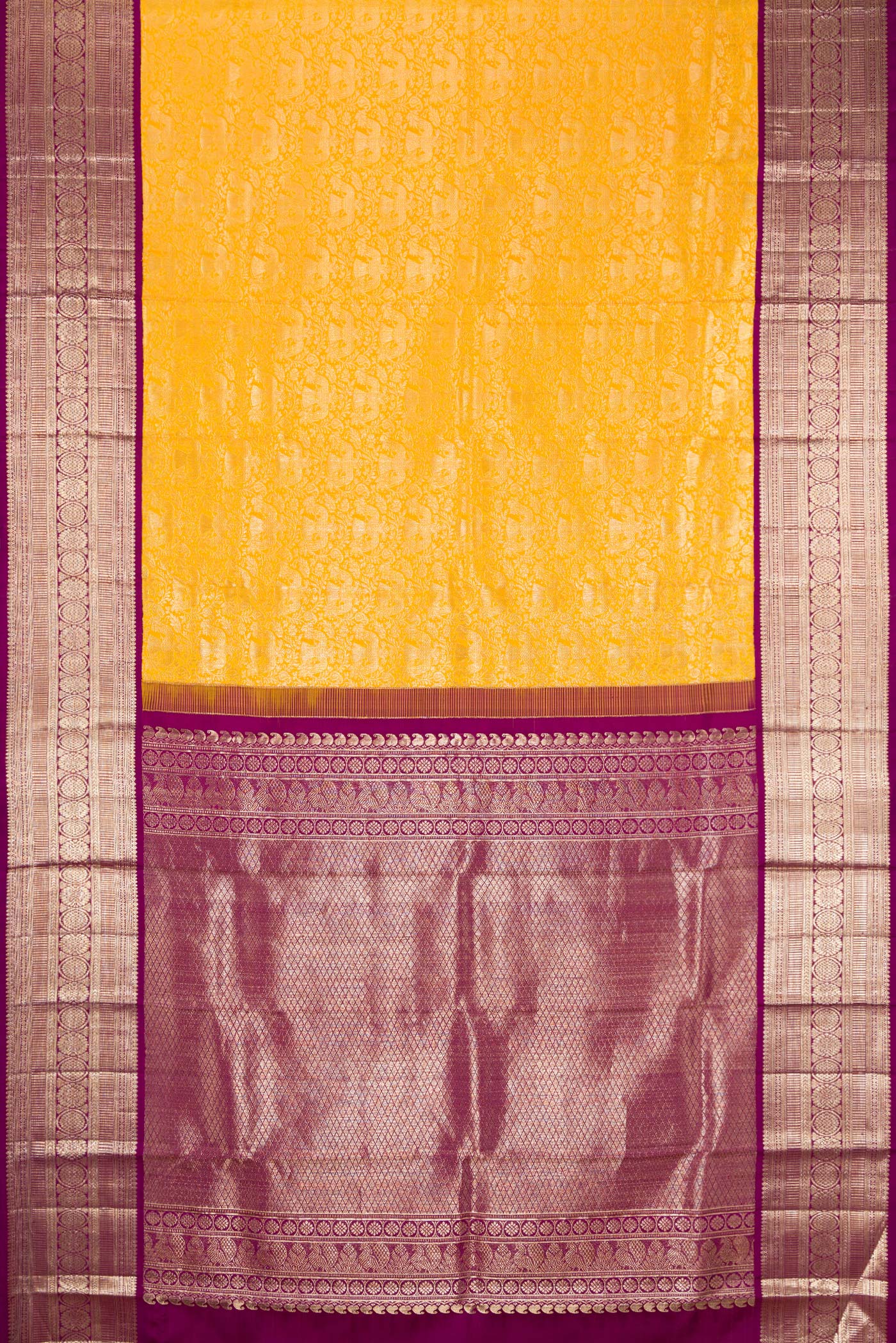 Flat view of Yellow Kanchipuram Silk Saree with Zari Brocade on the body and Zari Border. 