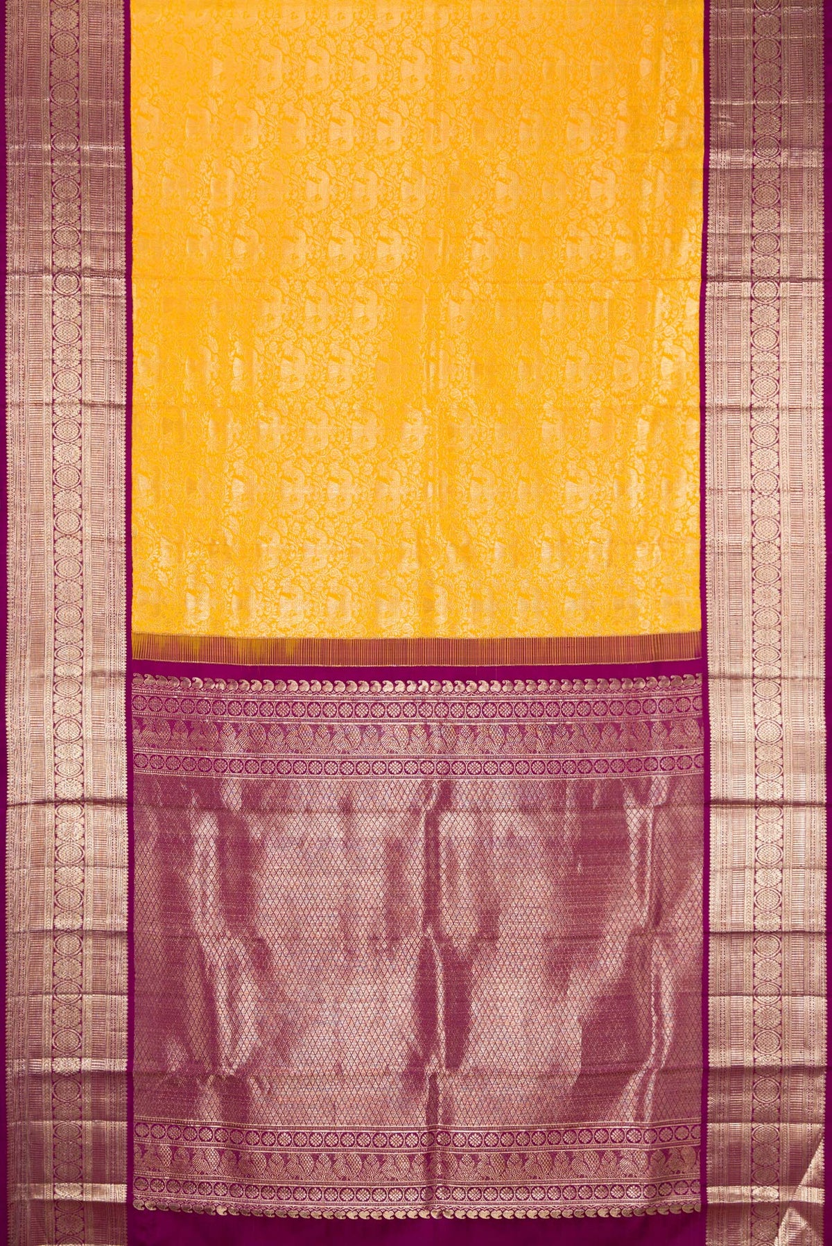 Flat view of Yellow Kanchipuram Silk Saree with Zari Brocade on the body and Zari Border. 