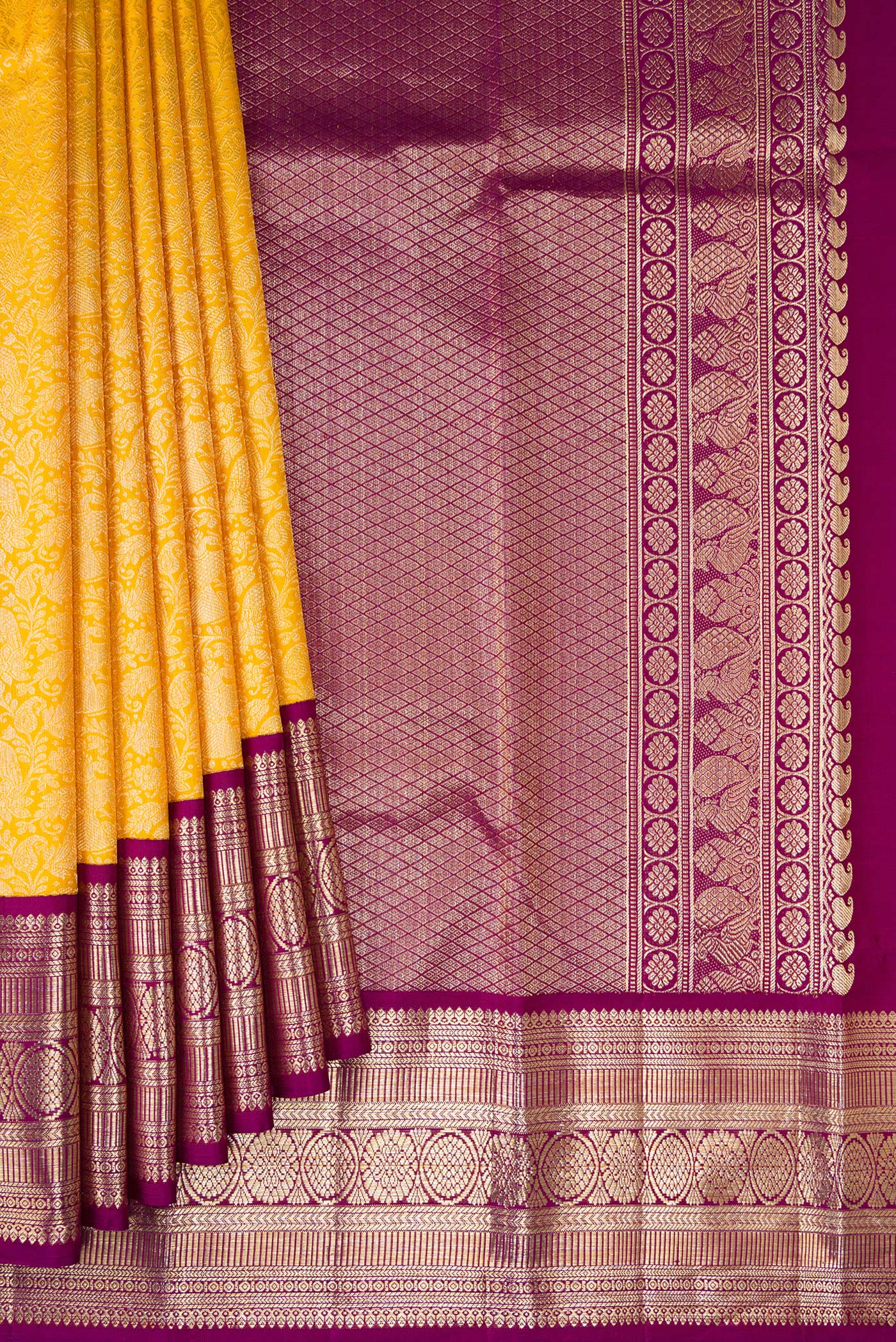 Pleats and pallu of Yellow Kanchipuram Silk Saree with Zari Brocade on the body and Zari Border. 