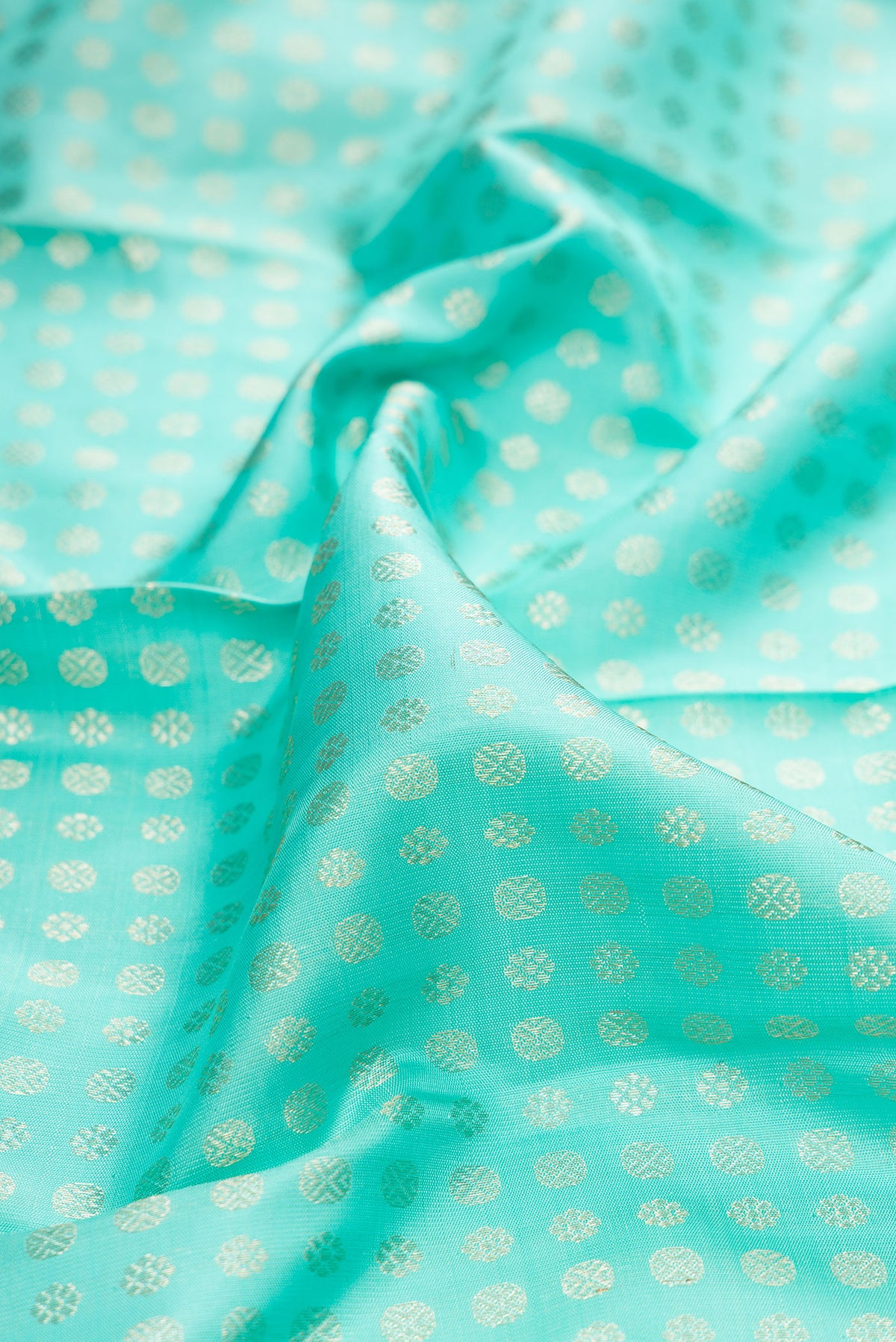 Close up of Pure Silk Sea Green Dual Tone Kanchipuram Saree with Zari Brocade on the body and Fancy Border.  displaying folds