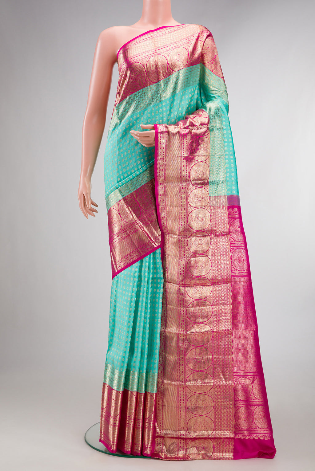 Pure Silk Sea Green Dual Tone Kanchipuram Saree with Zari Brocade on the body and Fancy Border.  displayed on a mannequin