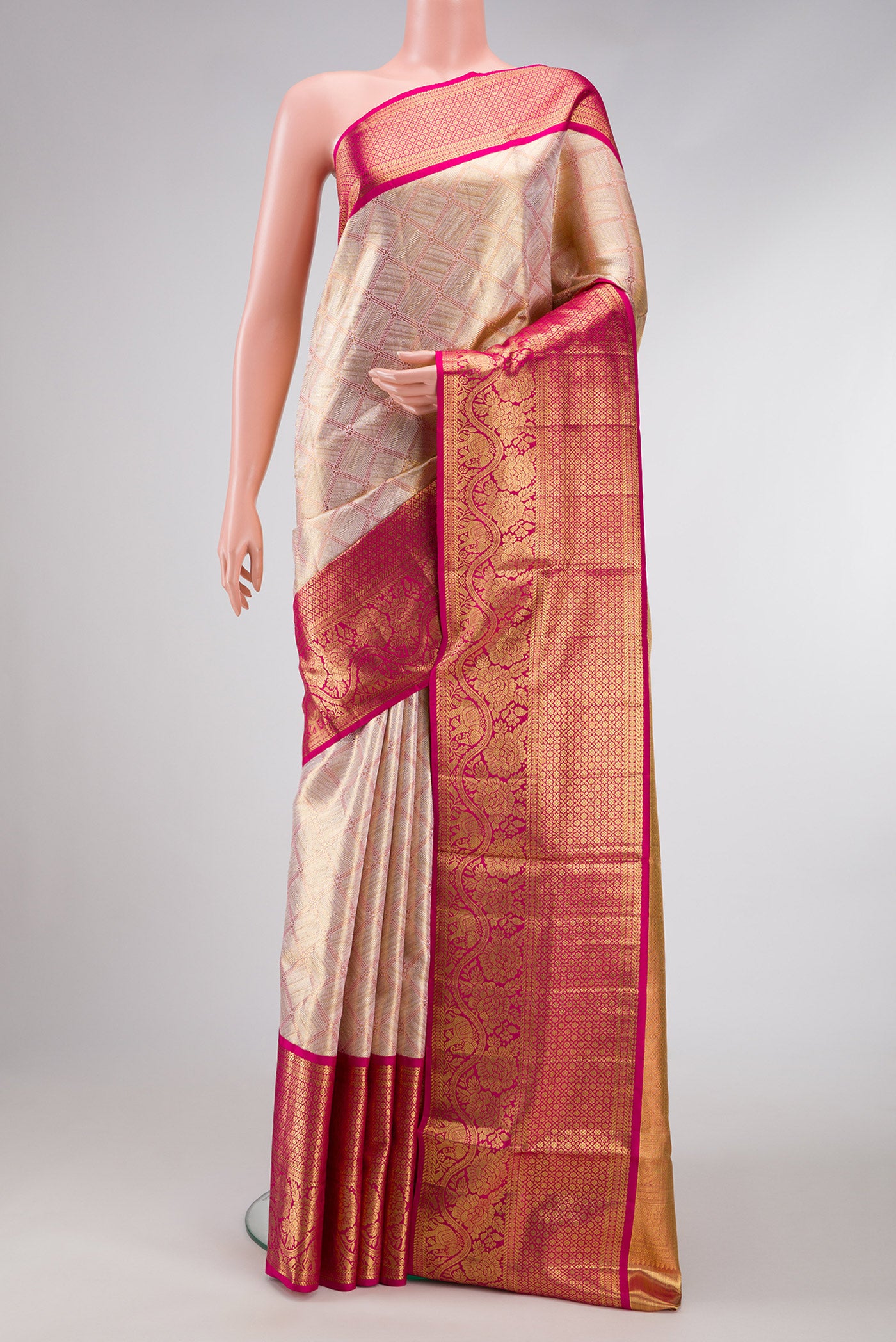 Rose Gold Dual Tone Kanjivaram Tissue Silk Saree with Zari Brocade on the body and Zari Border.  displayed on a mannequin