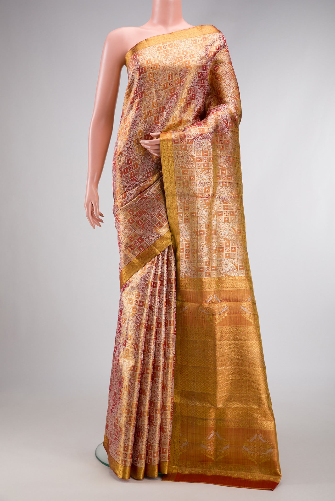 Gold Dual Tone Kanjivaram Tissue Silk Saree with Zari Brocade on the body and Zari Border.  displayed on a mannequin