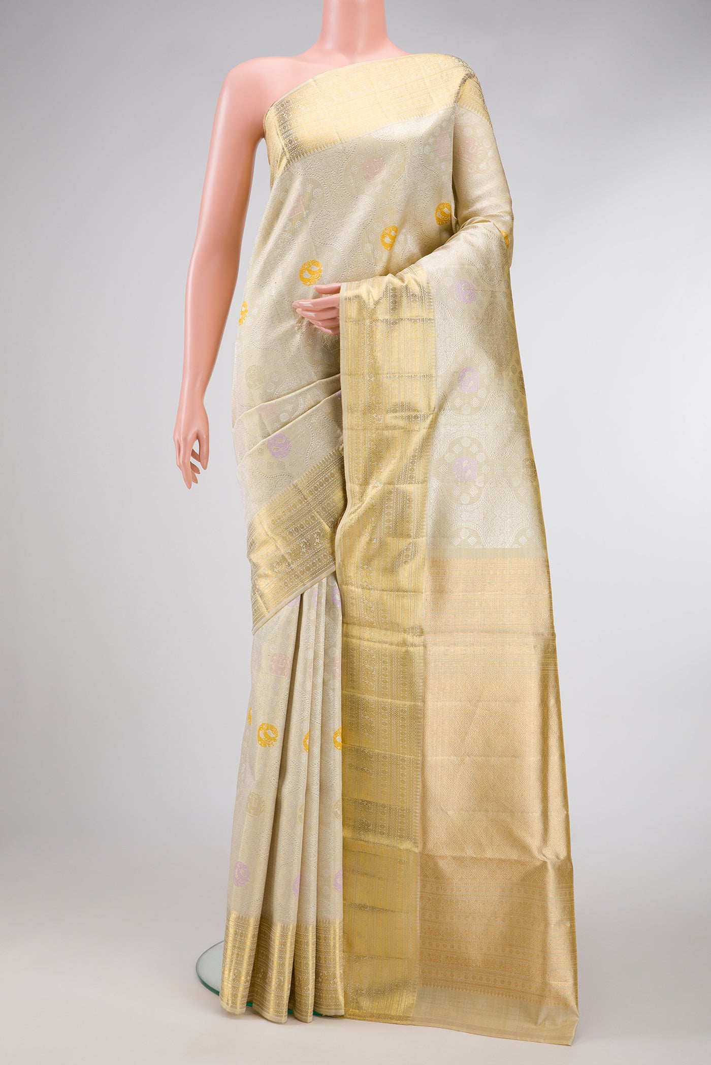Beige Dual Tone Kanjivaram Tissue Silk Saree with Zari Brocade on the body and Zari Border.  displayed on a mannequin
