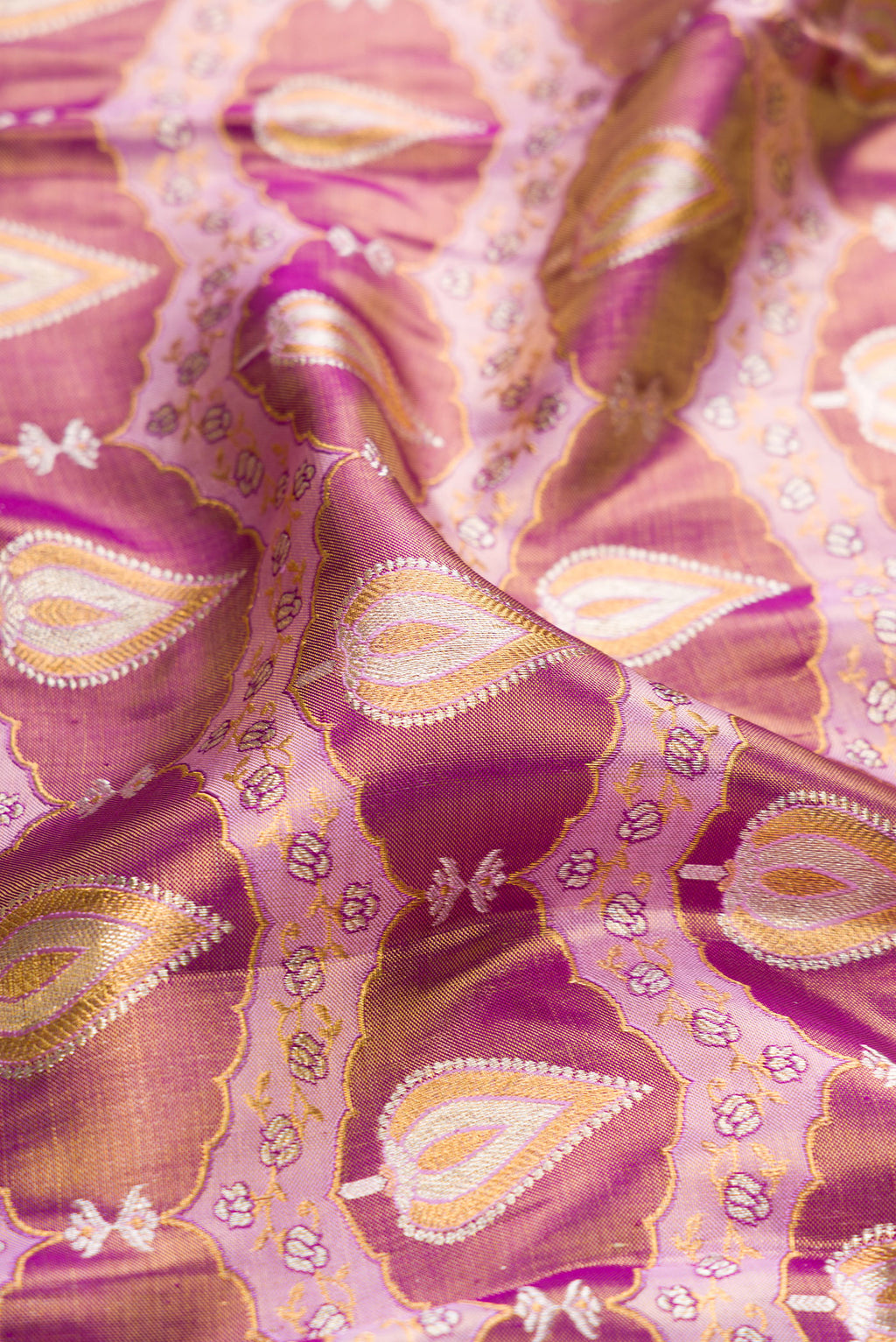 Close up of Purple Dual Tone Kanjivaram Tissue Silk Saree with Zari Brocade on the body and Zari Border.  displaying folds