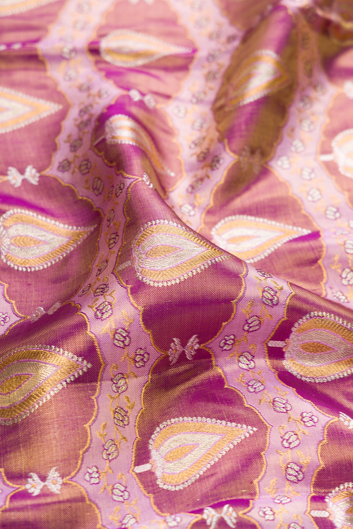 Close up of Purple Dual Tone Kanjivaram Tissue Silk Saree with Zari Brocade on the body and Zari Border.  displaying folds