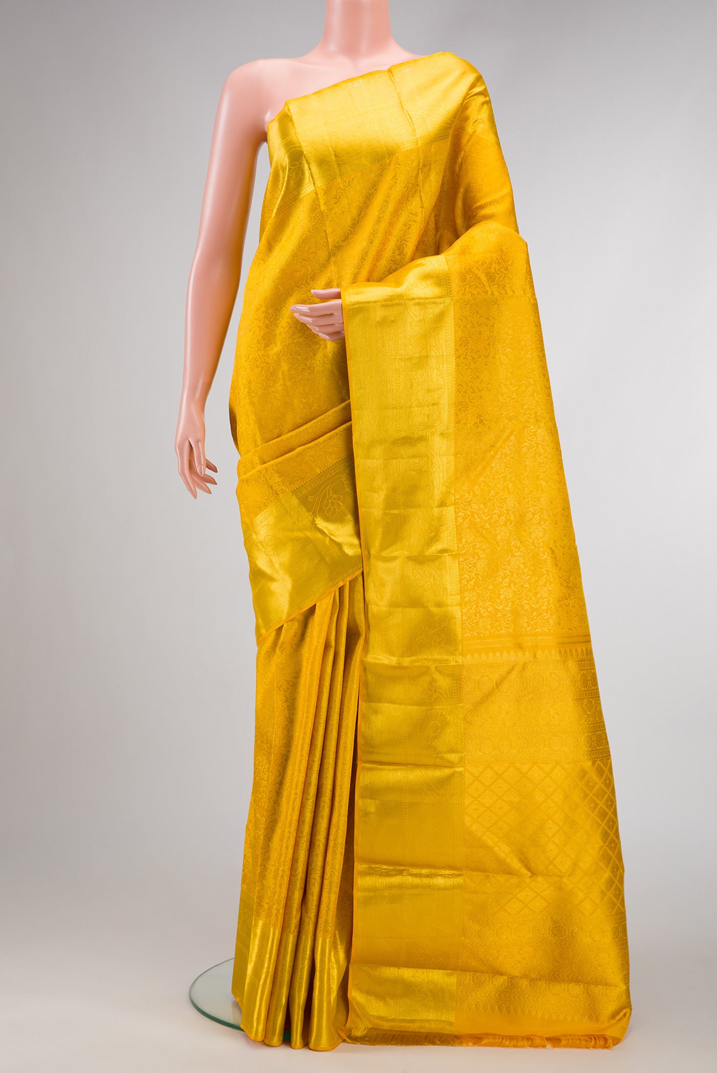 Yellow Dual Tone Kanchipuram Silk Saree with Zari Brocade on the body and Zari Border.  displayed on a mannequin