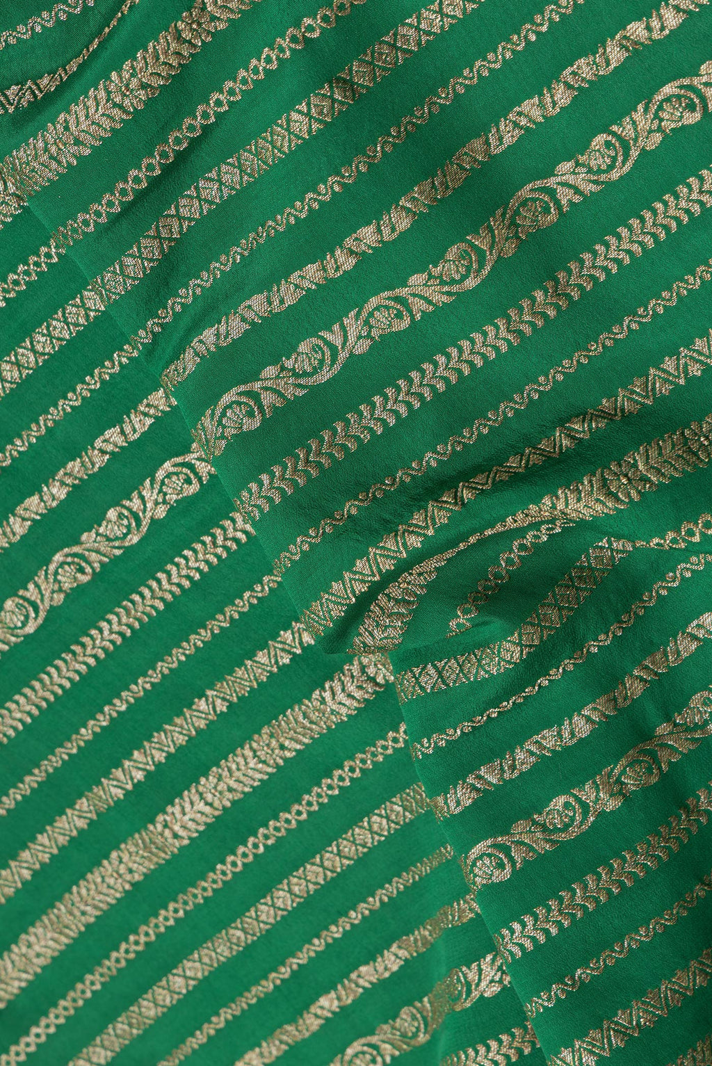 Close up of Green Dual Tone Banarasi Georgette Saree with Zari Brocade on the body and Zari Border.  displaying folds