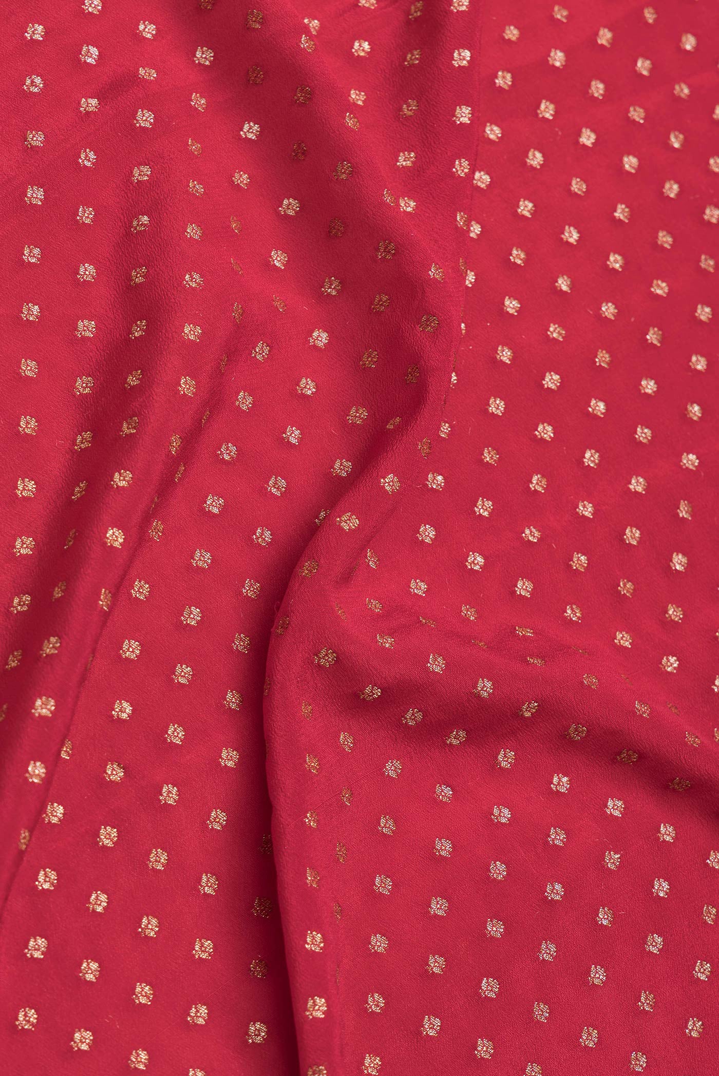 Close up of Red Dual Tone Banarasi Georgette Saree with Zari Butta on the body and Zari Border.  displaying folds