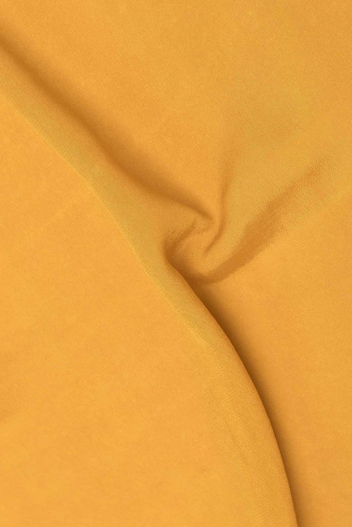 Close up of Mustard Dual Tone Banarasi Georgette Saree with Plain Body and Zari Border displaying folds