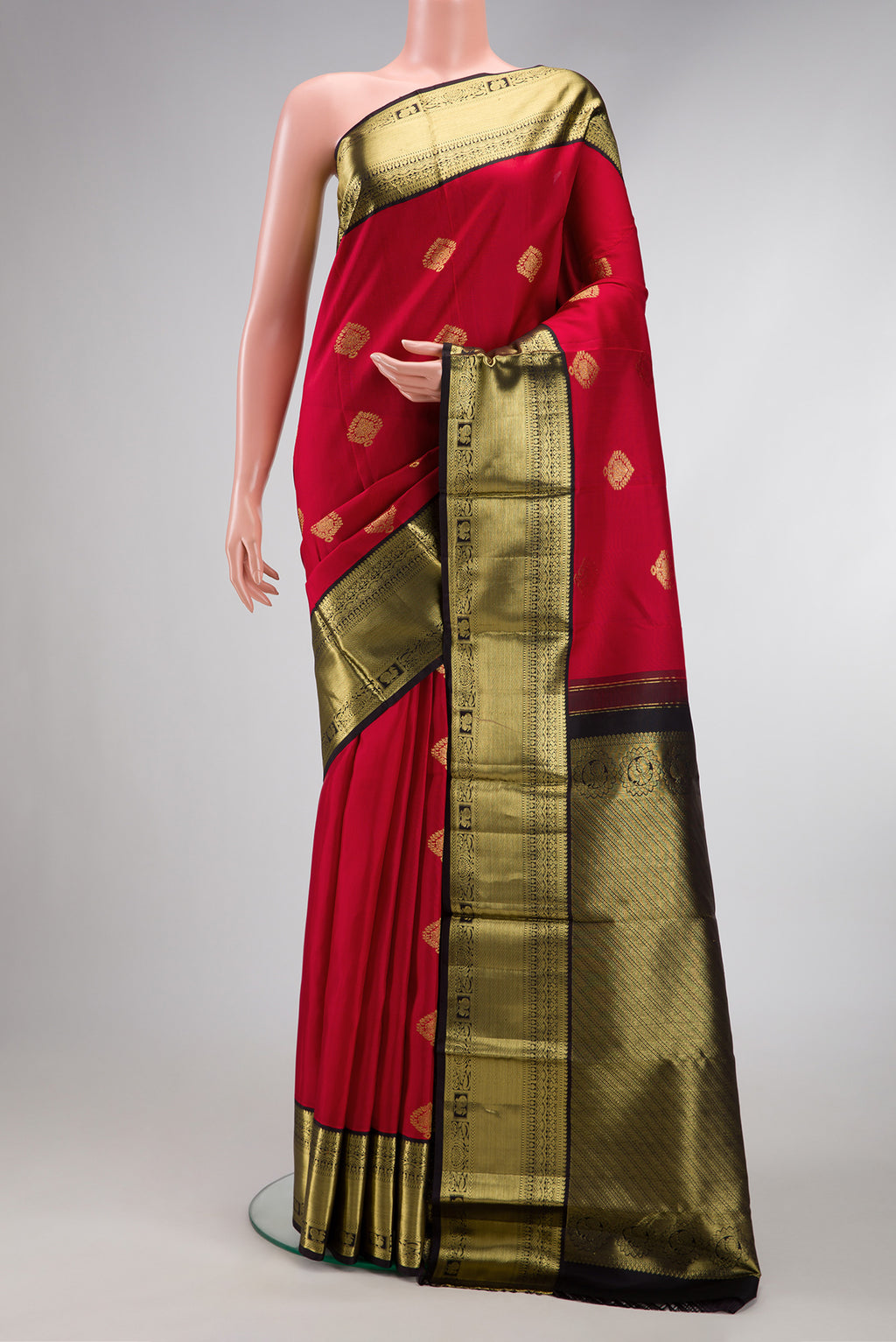 Maroon Dual Tone Kanjivaram Silk Saree with Zari Butta on the body and Fancy Border.  displayed on a mannequin