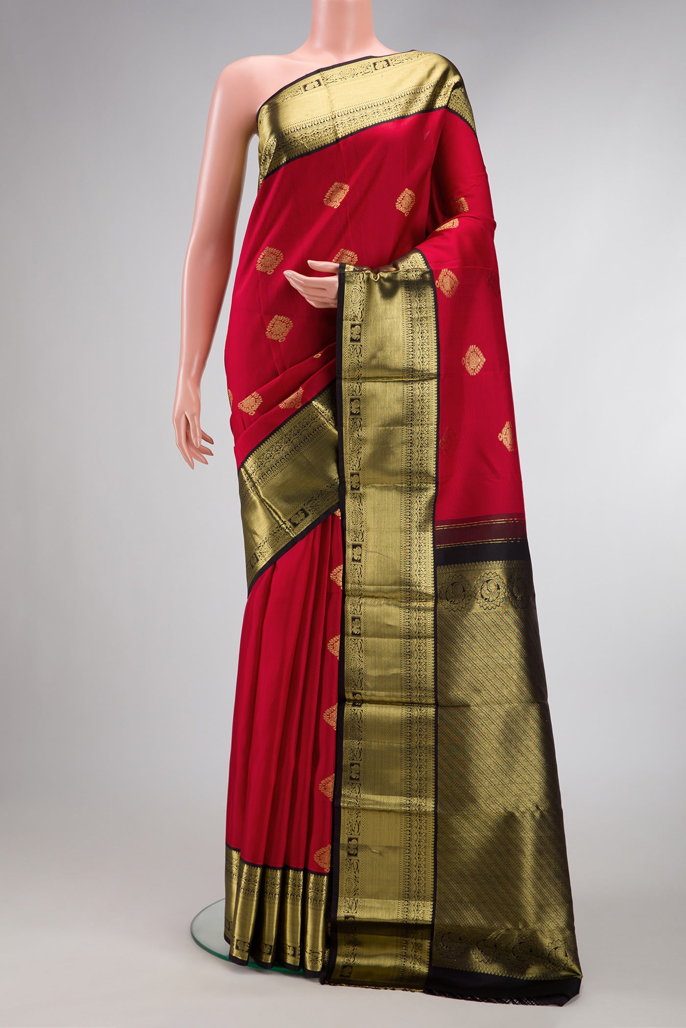 Maroon Dual Tone Kanjivaram Silk Saree with Zari Butta on the body and Fancy Border.  displayed on a mannequin