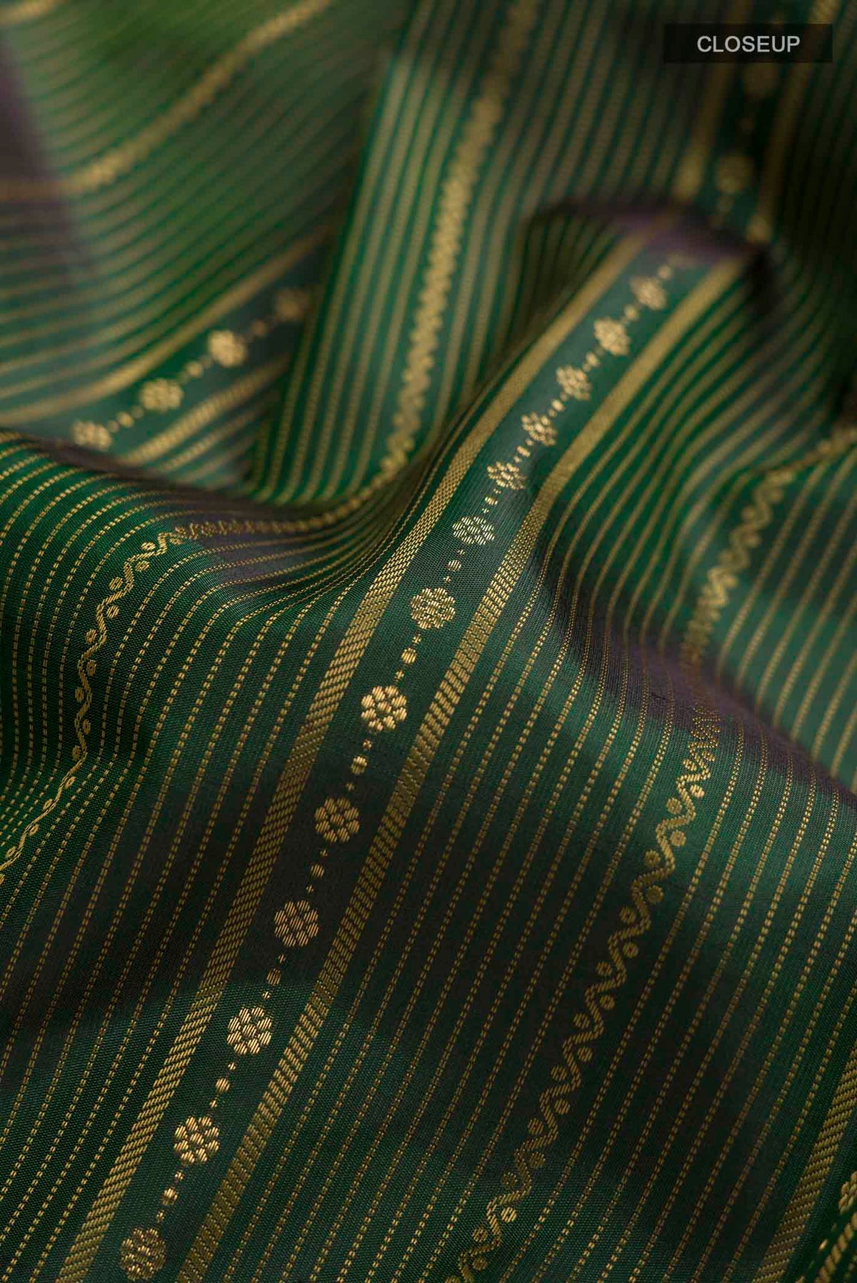 Close up of Green Kanchipuram Silk Saree with Stripes on the body and Without Border displaying folds