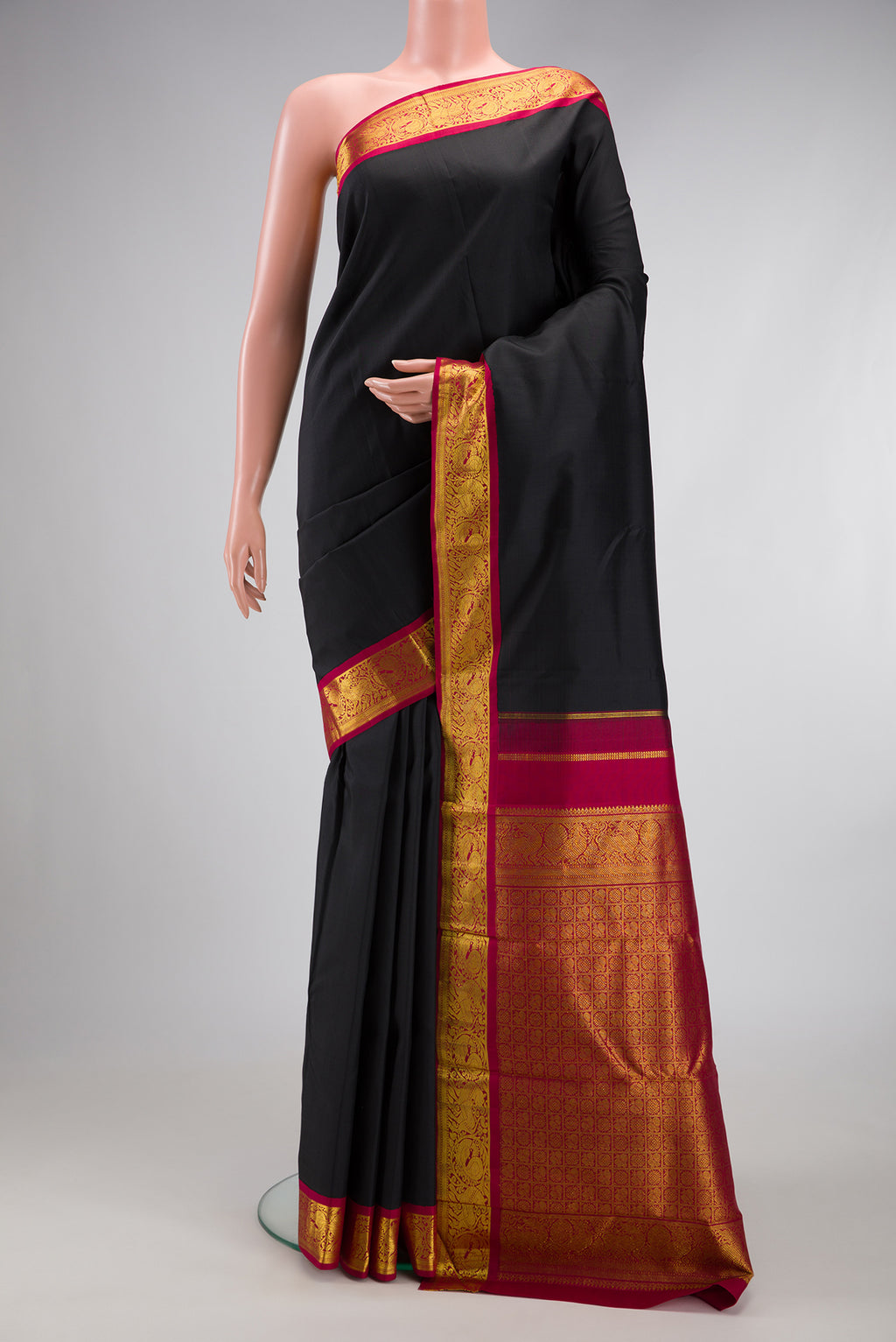 Black Kanjivaram Silk Saree with Plain Body and Zari Border.  displayed on a mannequin