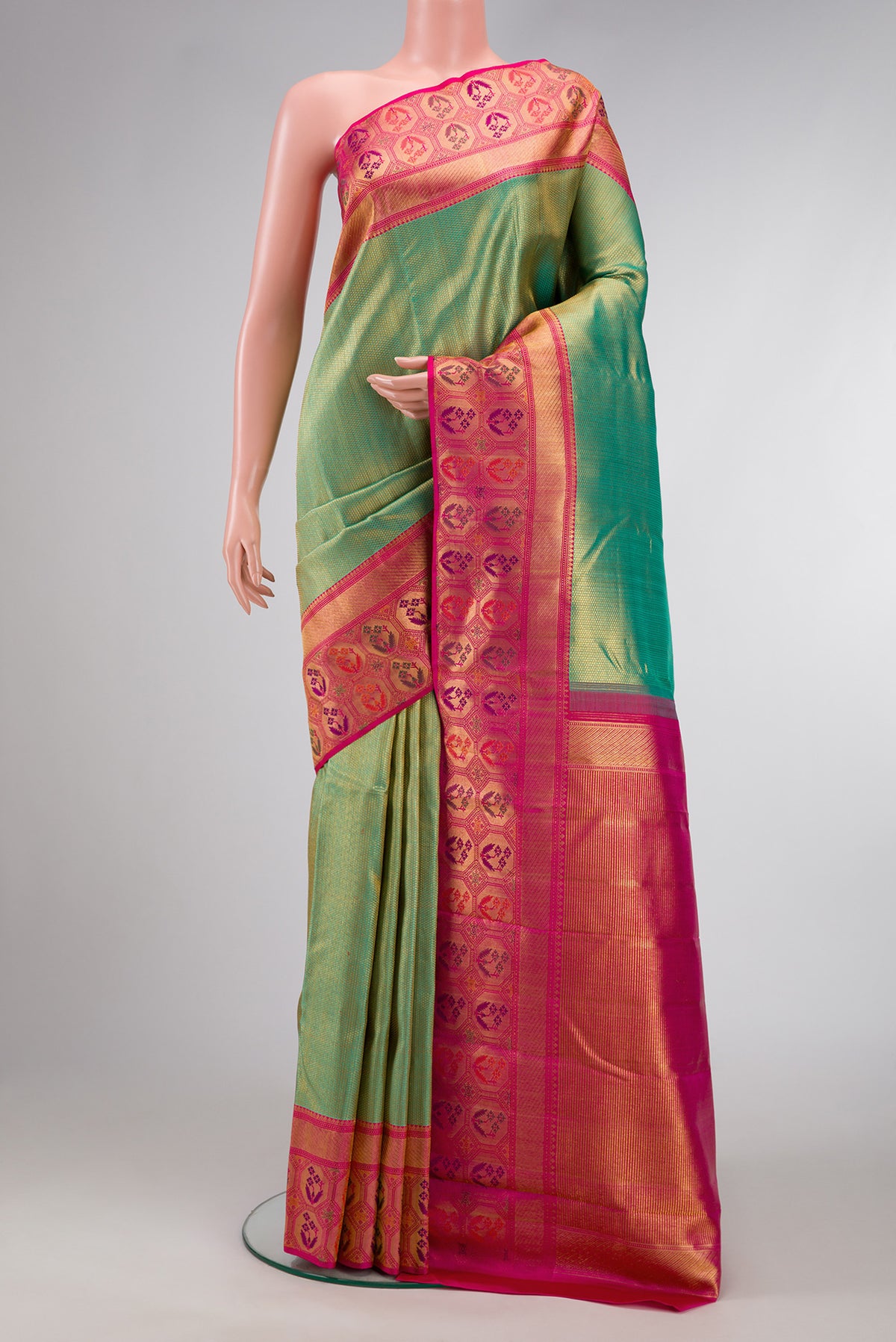 Mehandi Green Dual Tone Kanchipuram Silk Saree with Zari Brocade on the body and Fancy Border.  displayed on a mannequin