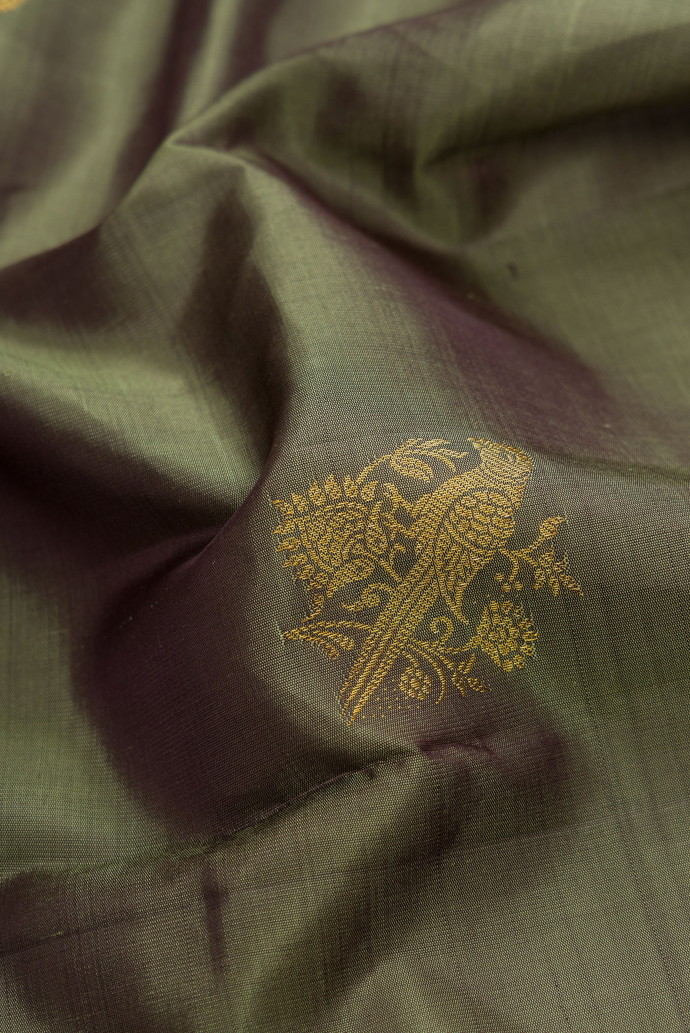 Close up of Mehandi Green Dual Tone Kanjivaram Silk Saree with Zari Butta on the body and Fancy Border.  displaying folds