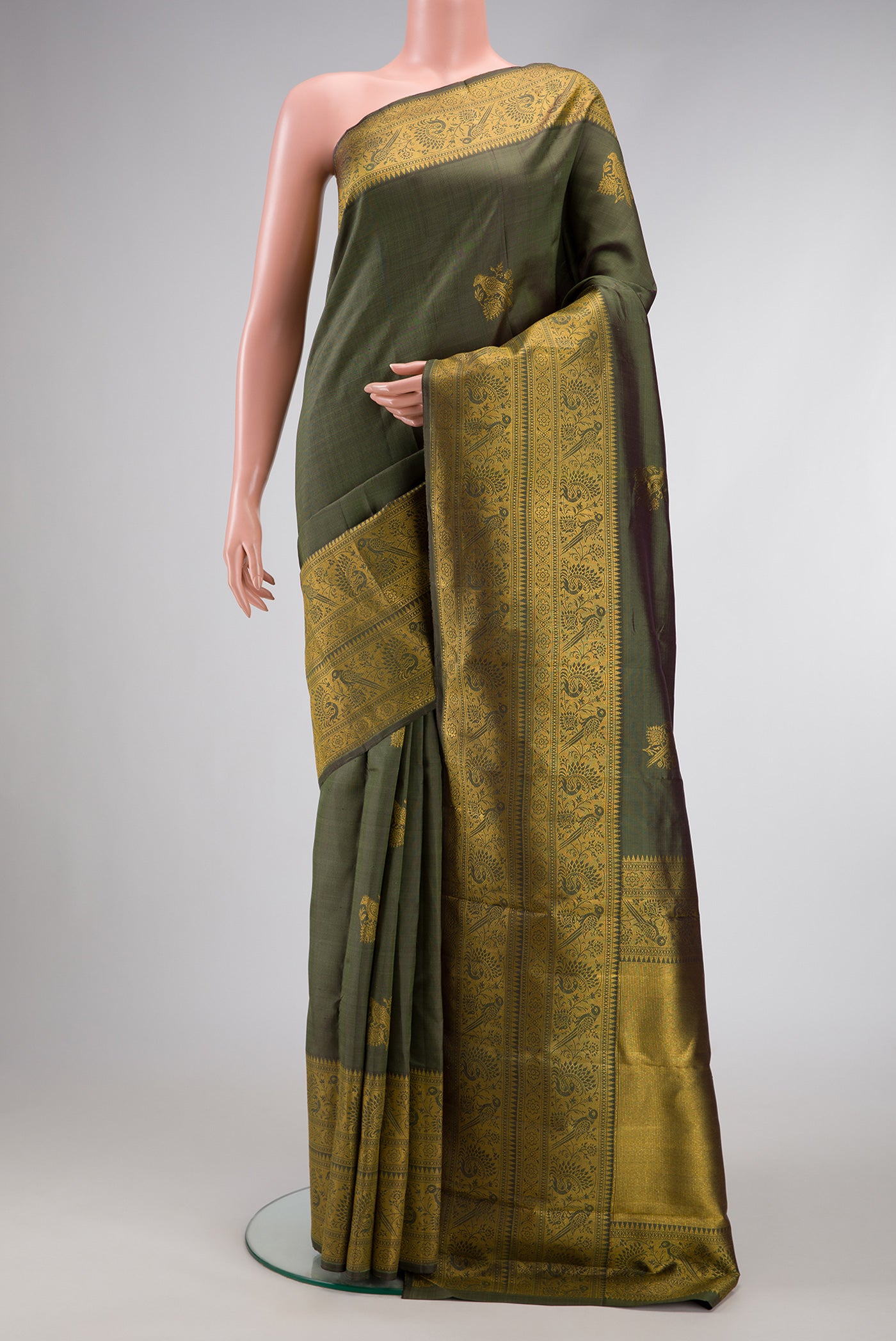 Mehandi Green Dual Tone Kanjivaram Silk Saree with Zari Butta on the body and Fancy Border.  displayed on a mannequin