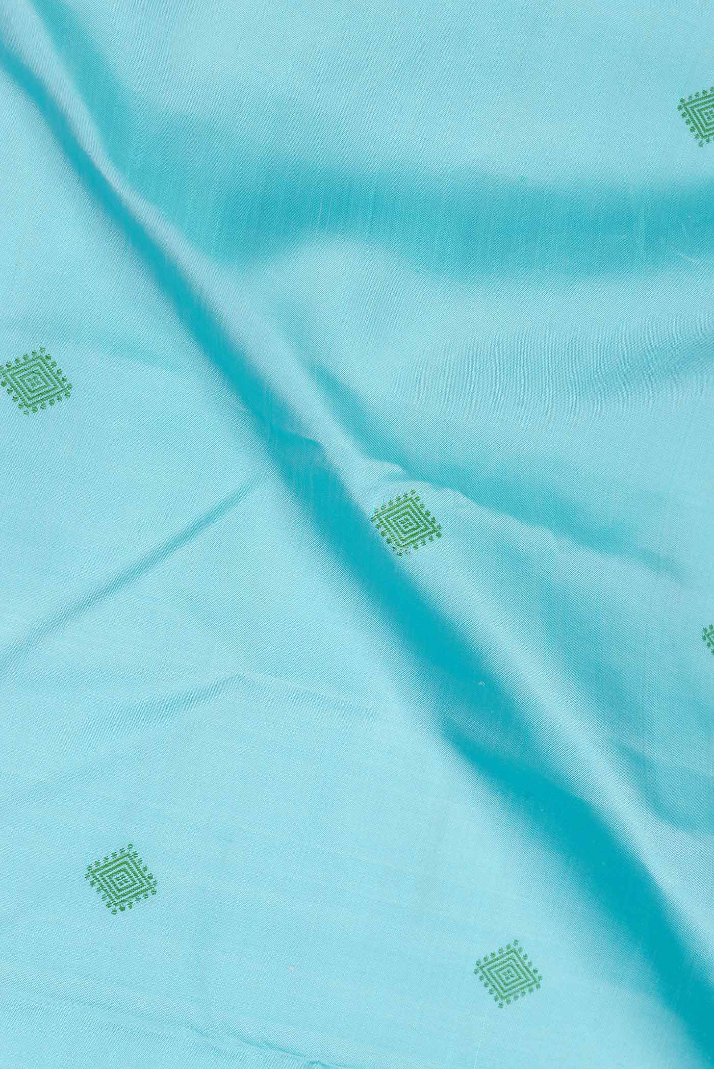 Close up of Sky Blue Dual Tone Kanjivaram Saree with Thread Butta on the body and Thread Border.  displaying folds