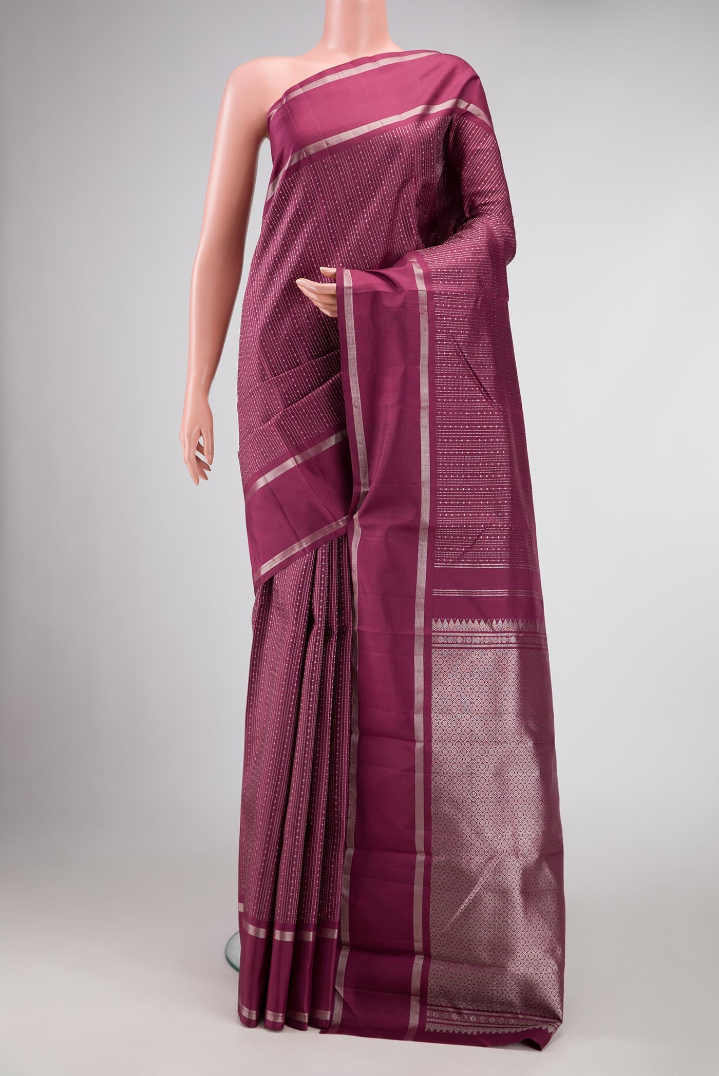 Maroon Dual Tone Kanchipuram Silk Saree with Stripes on the body and Zari Border displayed on a mannequin