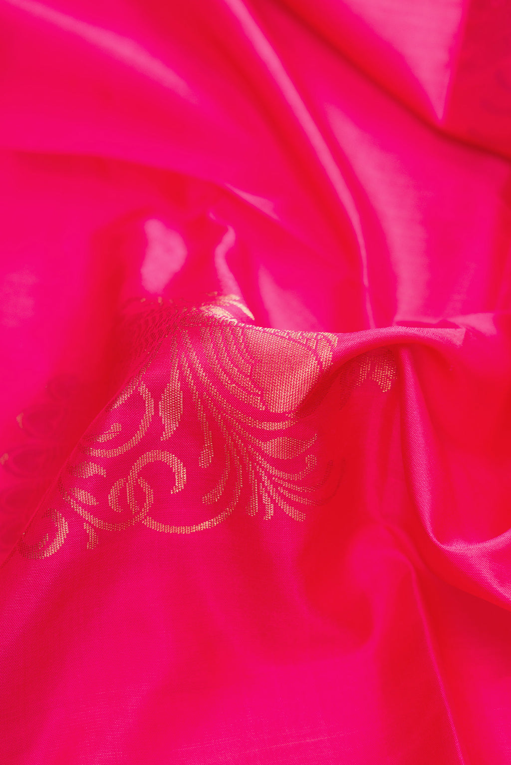 Close up of Pink Dual Tone Soft Silk Saree with Zari Butta on the body and Zari Border.  displaying folds