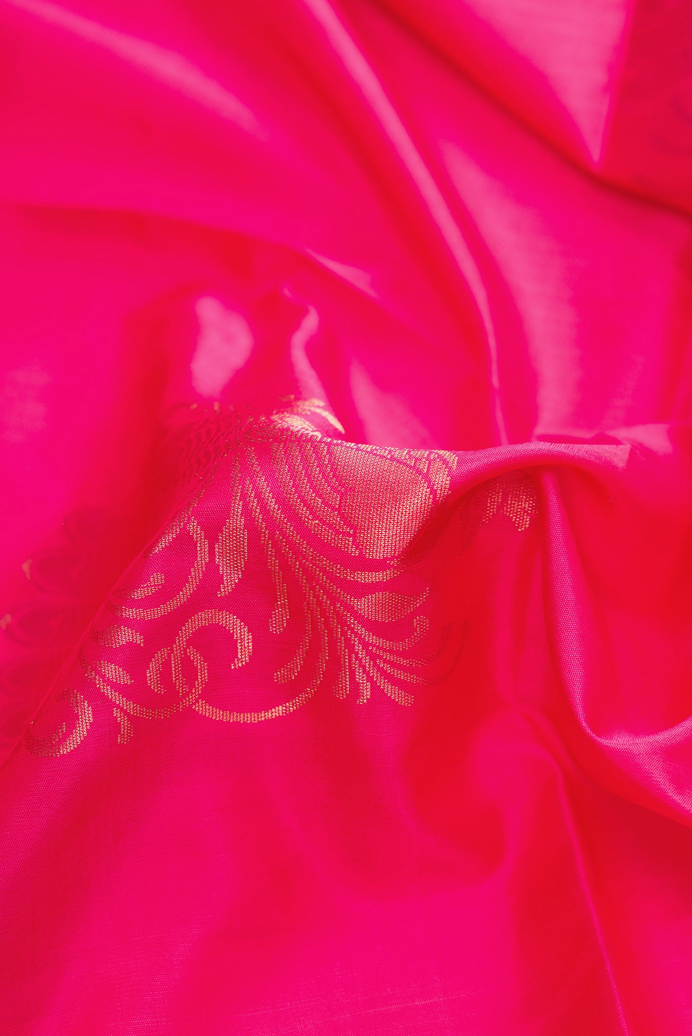 Close up of Pink Dual Tone Soft Silk Saree with Zari Butta on the body and Zari Border.  displaying folds