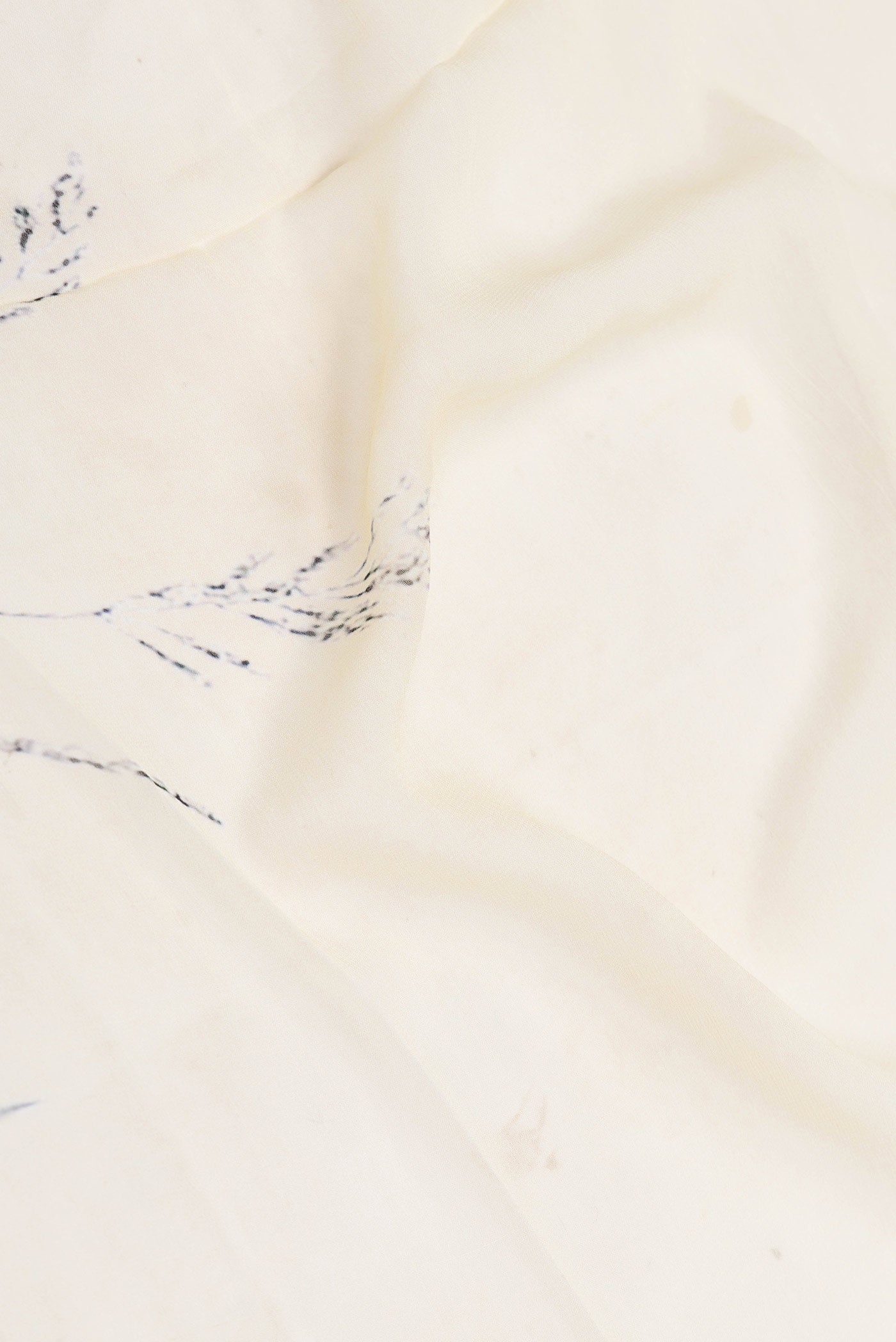 Close up of Sandal Dual Tone Georgette Saree with Printed design on the body and Zari Border displaying folds