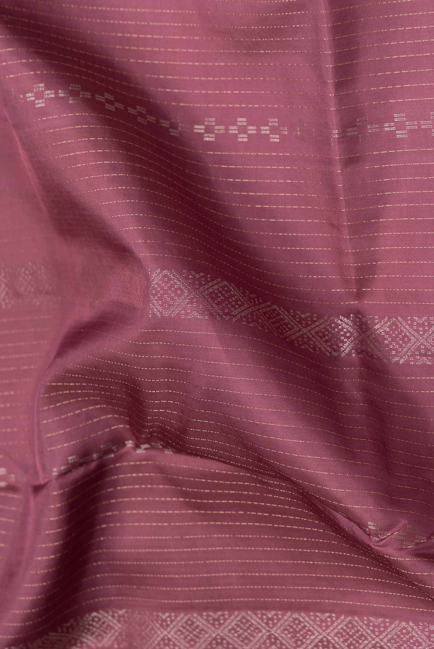 Close up of Maroon Dual Tone Soft Silk Saree with Stripes on the body and Without Border.  displaying folds