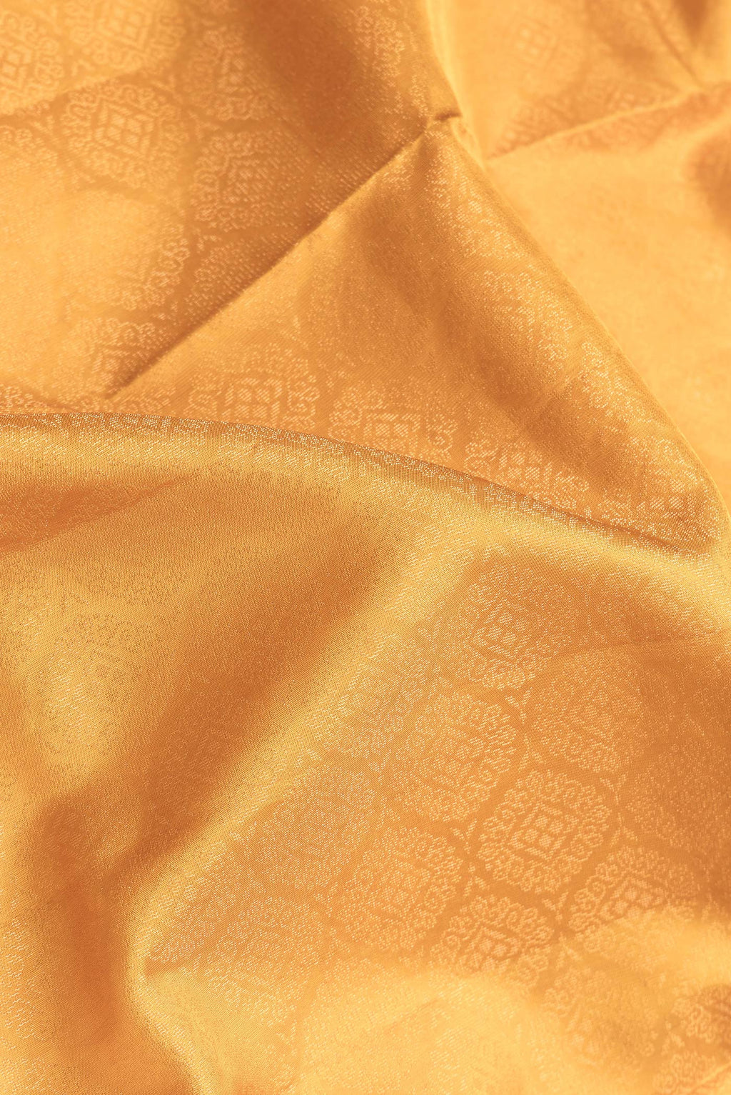 Close up of Yellow Dual Tone Soft Silk Saree with Zari Brocade on the body and Zari Border.  displaying folds