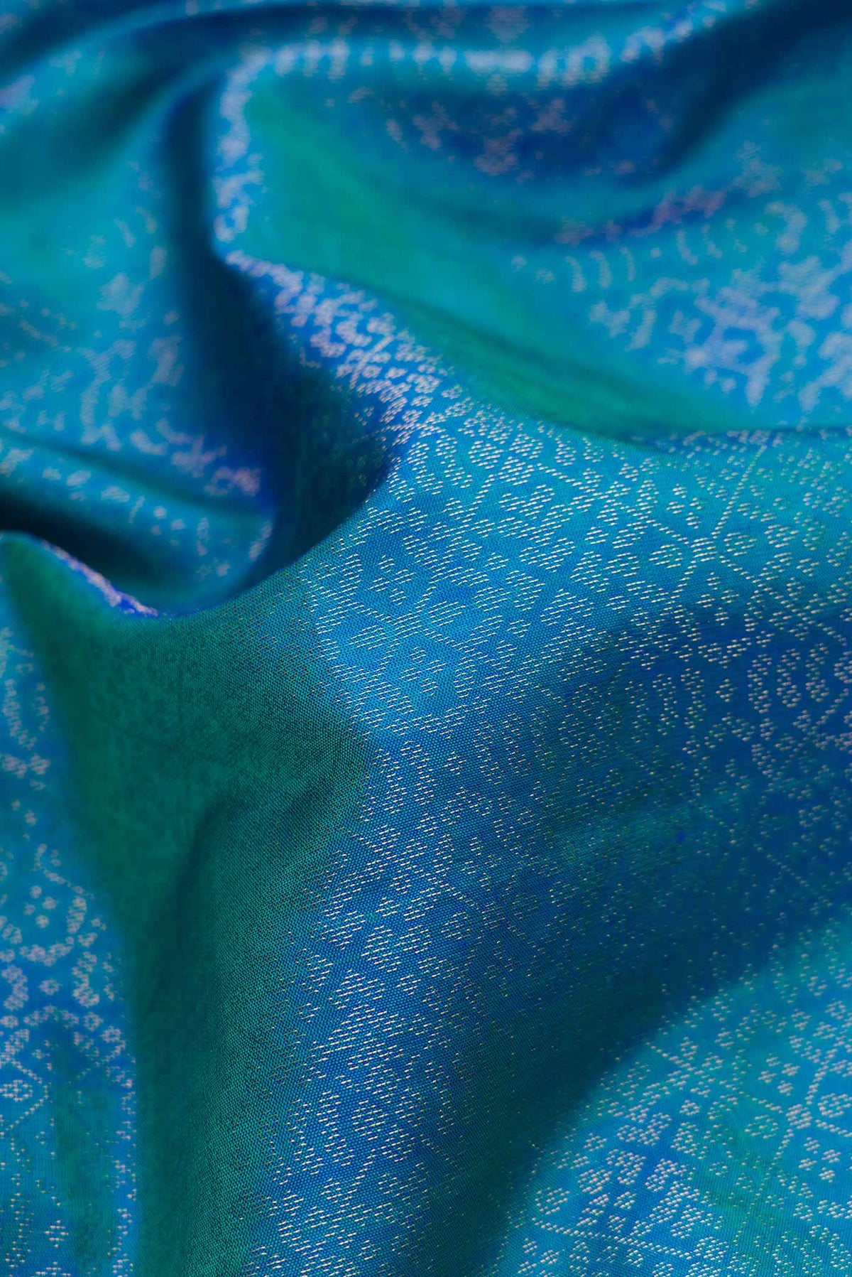 Close up of Peacock Blue Dual Tone Soft Silk Saree with Zari Brocade on the body and Zari Border.  displaying folds