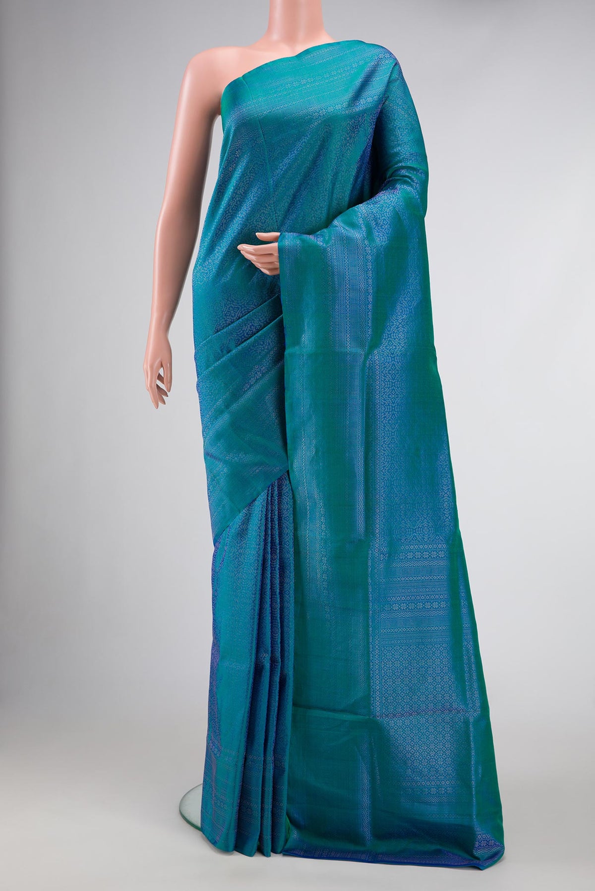 Peacock Blue Dual Tone Soft Silk Saree with Zari Brocade on the body and Zari Border.  displayed on a mannequin