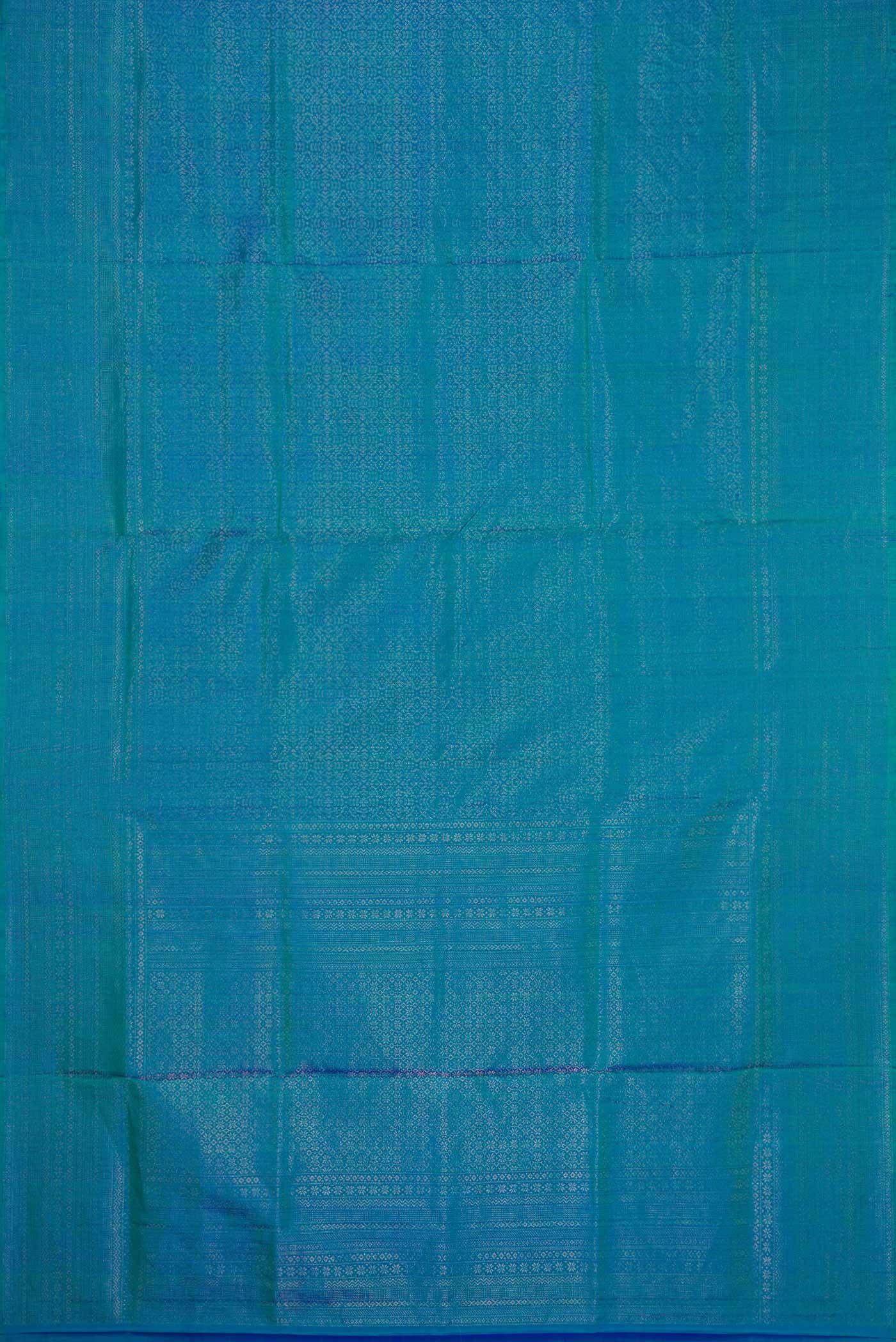Flat view of Peacock Blue Dual Tone Soft Silk Saree with Zari Brocade on the body and Zari Border. 
