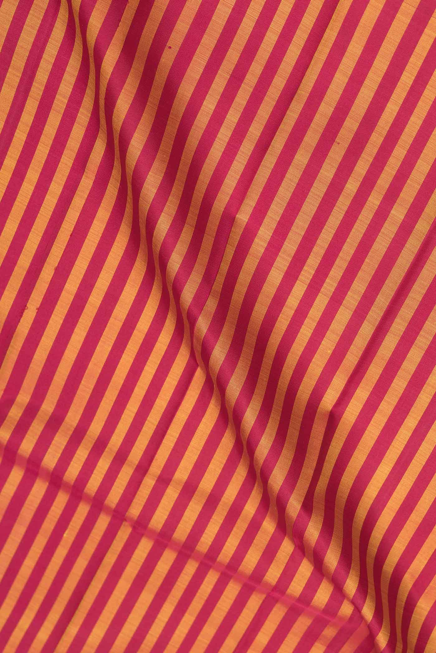 Close up of Maroon Dual Tone Kanjivaram Saree with Stripes on the body and Without Border.  displaying folds