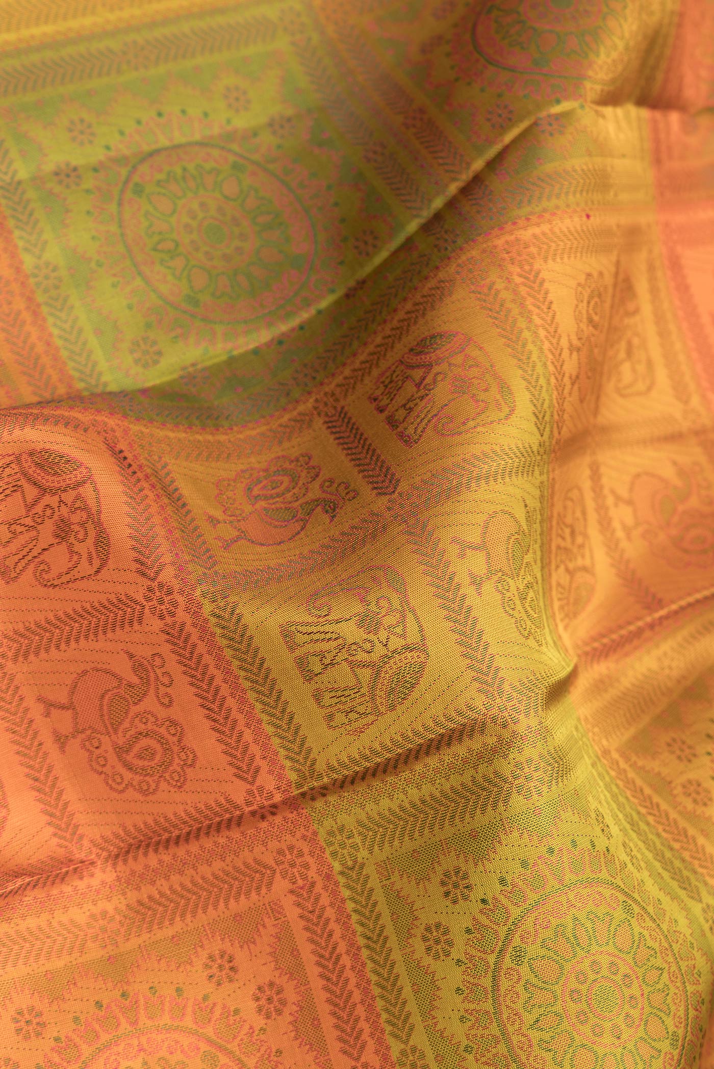 Close up of Mustard Dual Tone Kanjivaram Silk Saree with Jacquard design on the body and Zari Border.  displaying folds