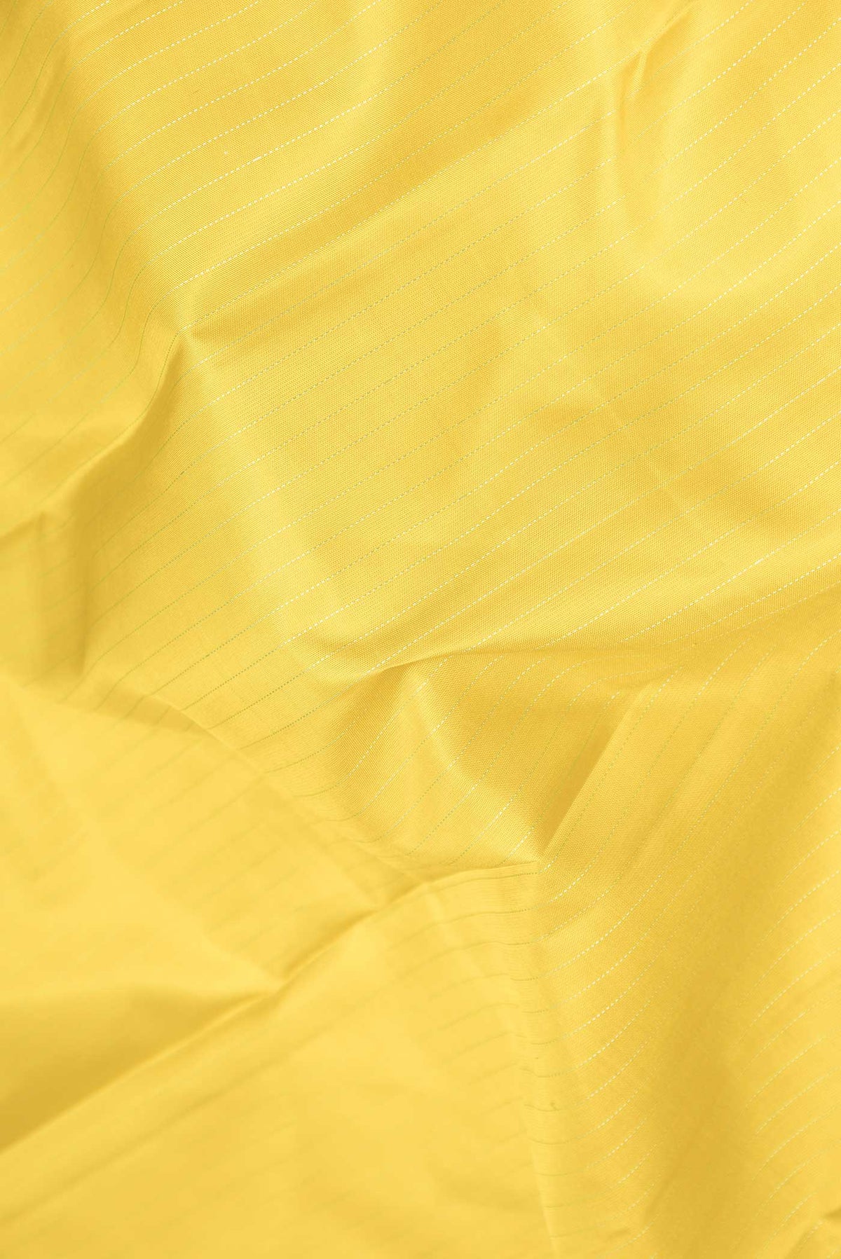 Close up of Yellow Dual Tone Kanchipuram Saree with Stripes on the body and Fancy Border displaying folds