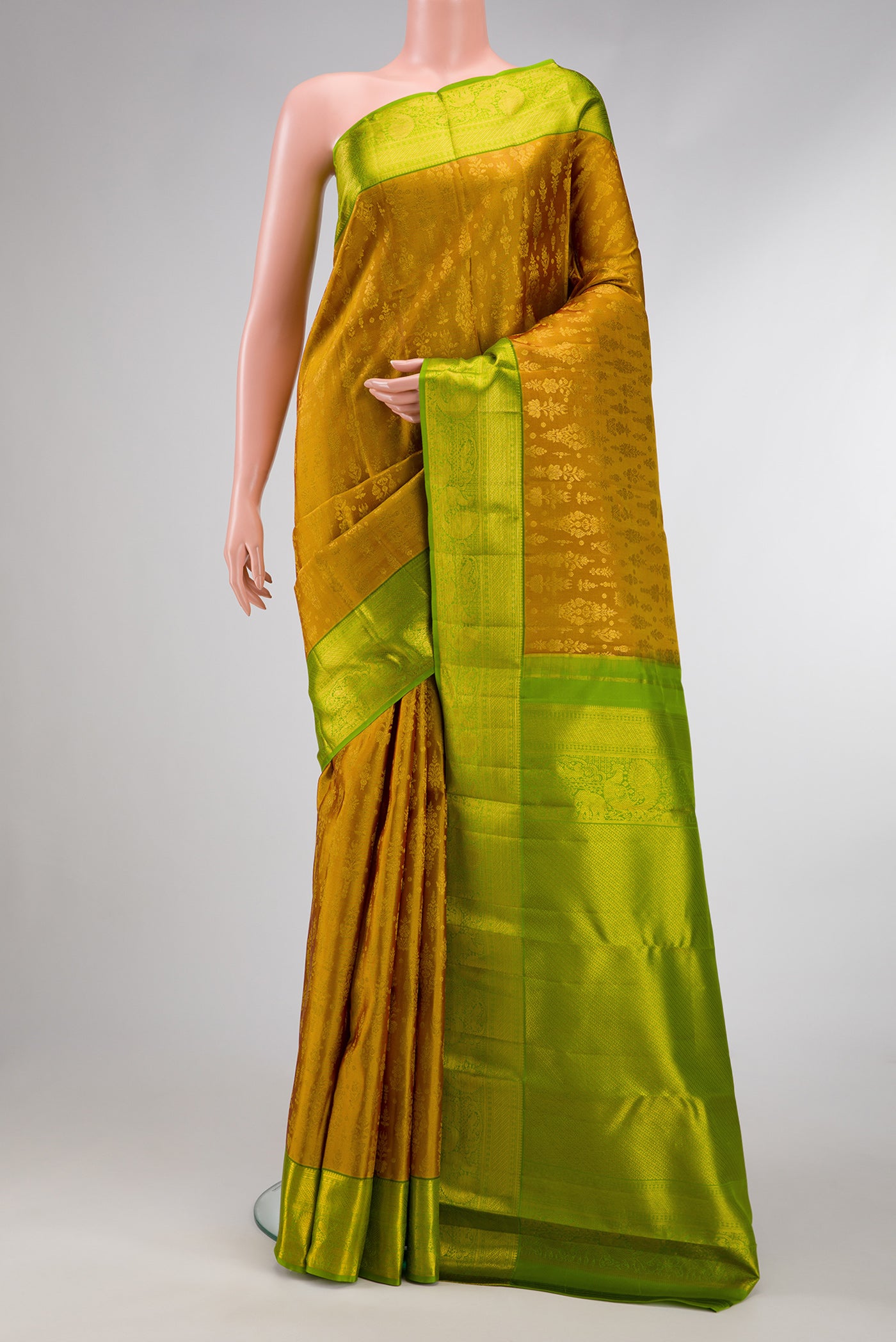 Gold Dual Tone Kanchipuram Silk Saree with Zari Brocade on the body and Zari Border.  displayed on a mannequin