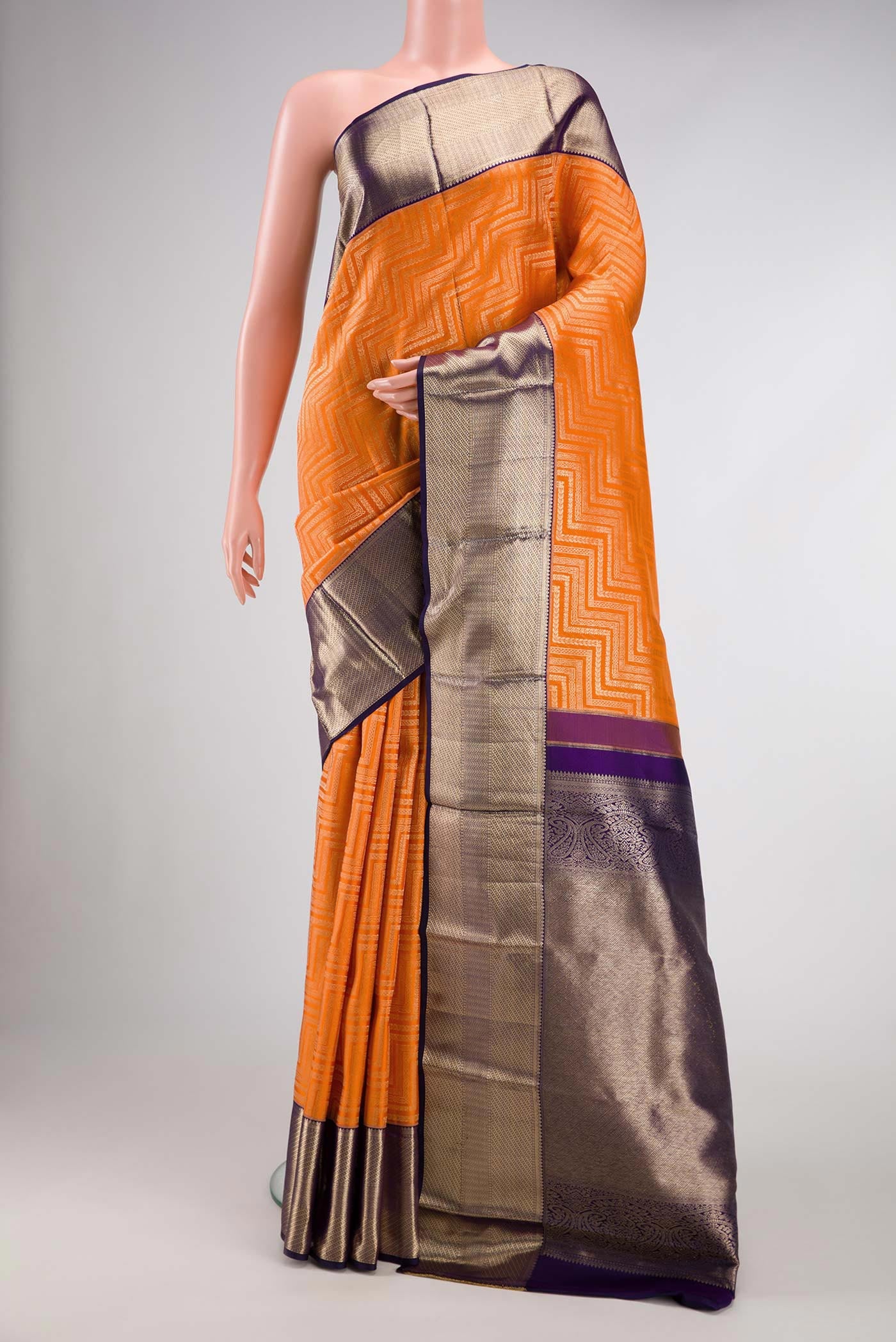 Orange Dual Tone Kanchipuram Silk Saree with Zari Brocade on the body and Zari Border.  displayed on a mannequin