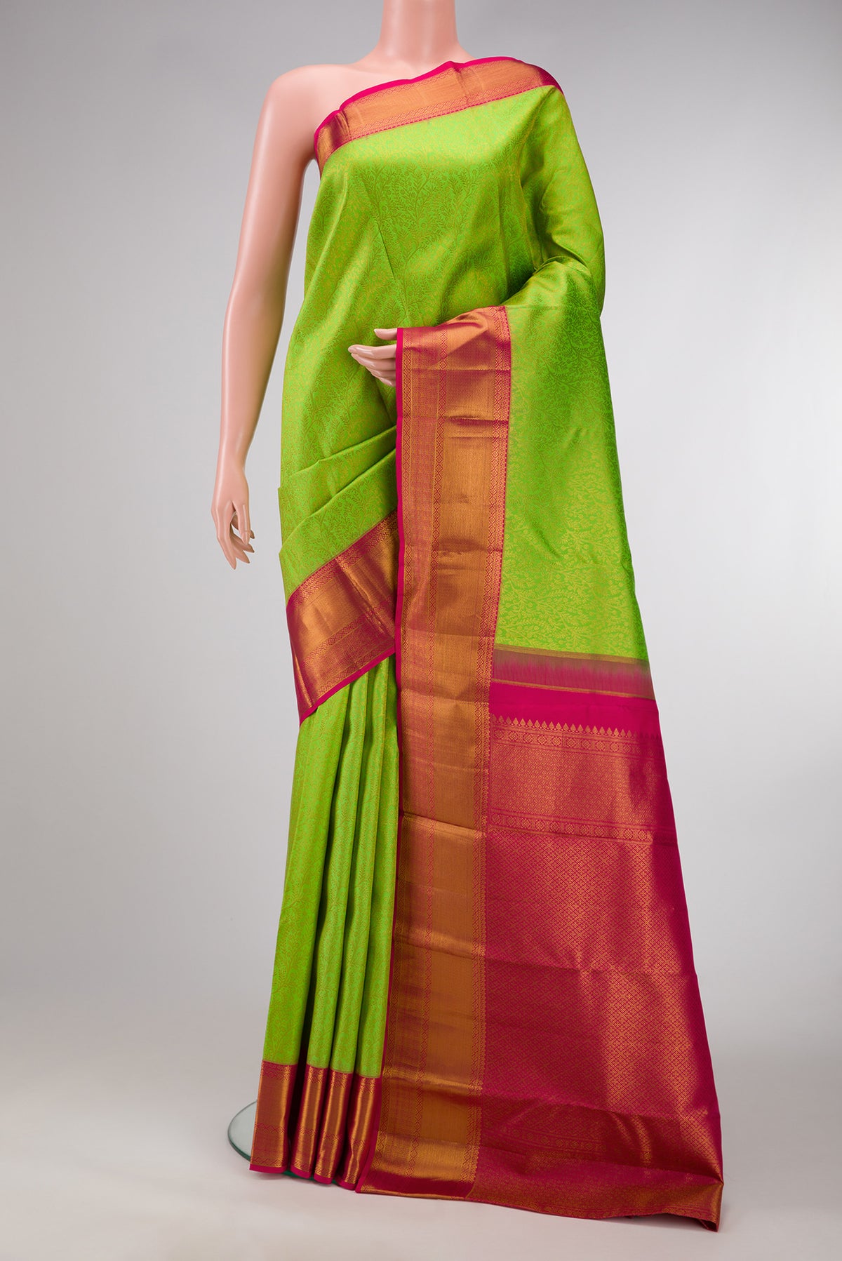Parrot Green Dual Tone Kanchipuram Silk Saree with Zari Brocade on the body and Zari Border.  displayed on a mannequin