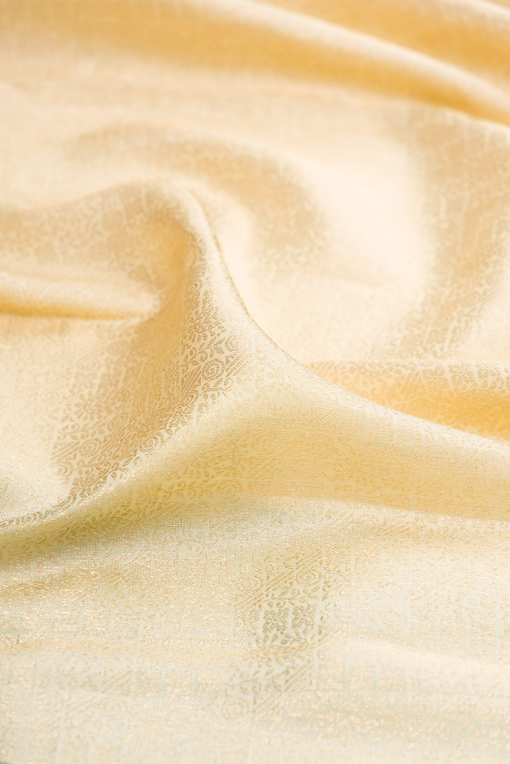 Close up of Off White Kanchipuram Silk Saree with Zari Brocade on the body and Zari Border.  displaying folds