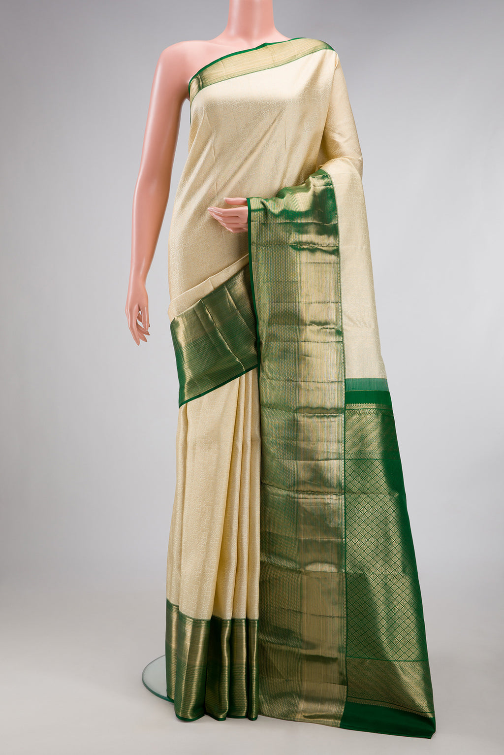 Off White Kanchipuram Silk Saree with Zari Brocade on the body and Zari Border.  displayed on a mannequin