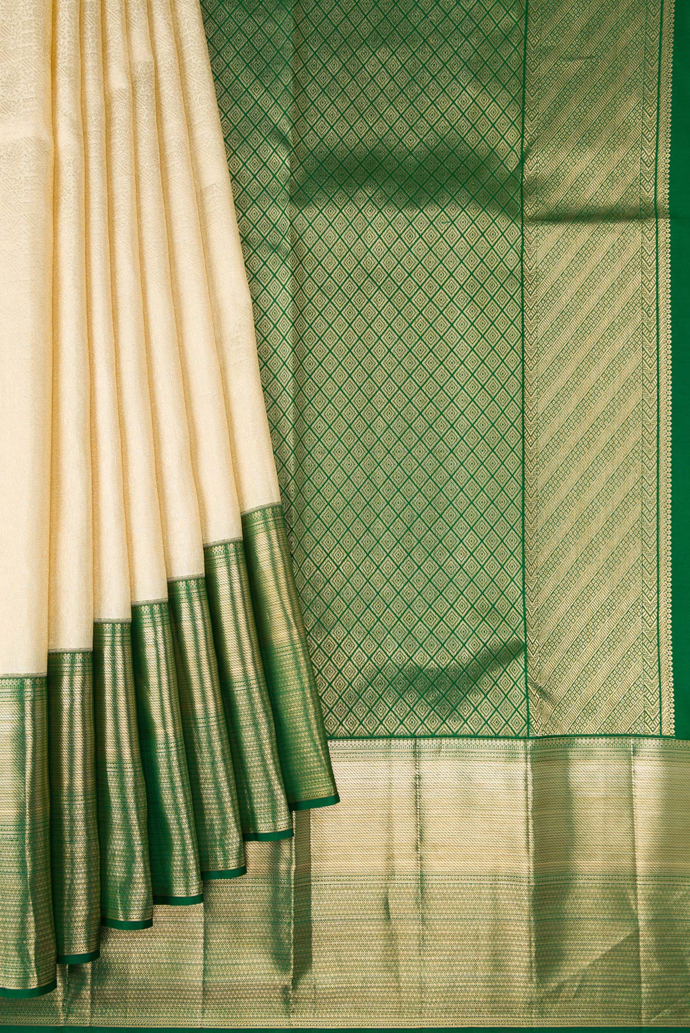 Pleats and pallu of Off White Kanchipuram Silk Saree with Zari Brocade on the body and Zari Border. 