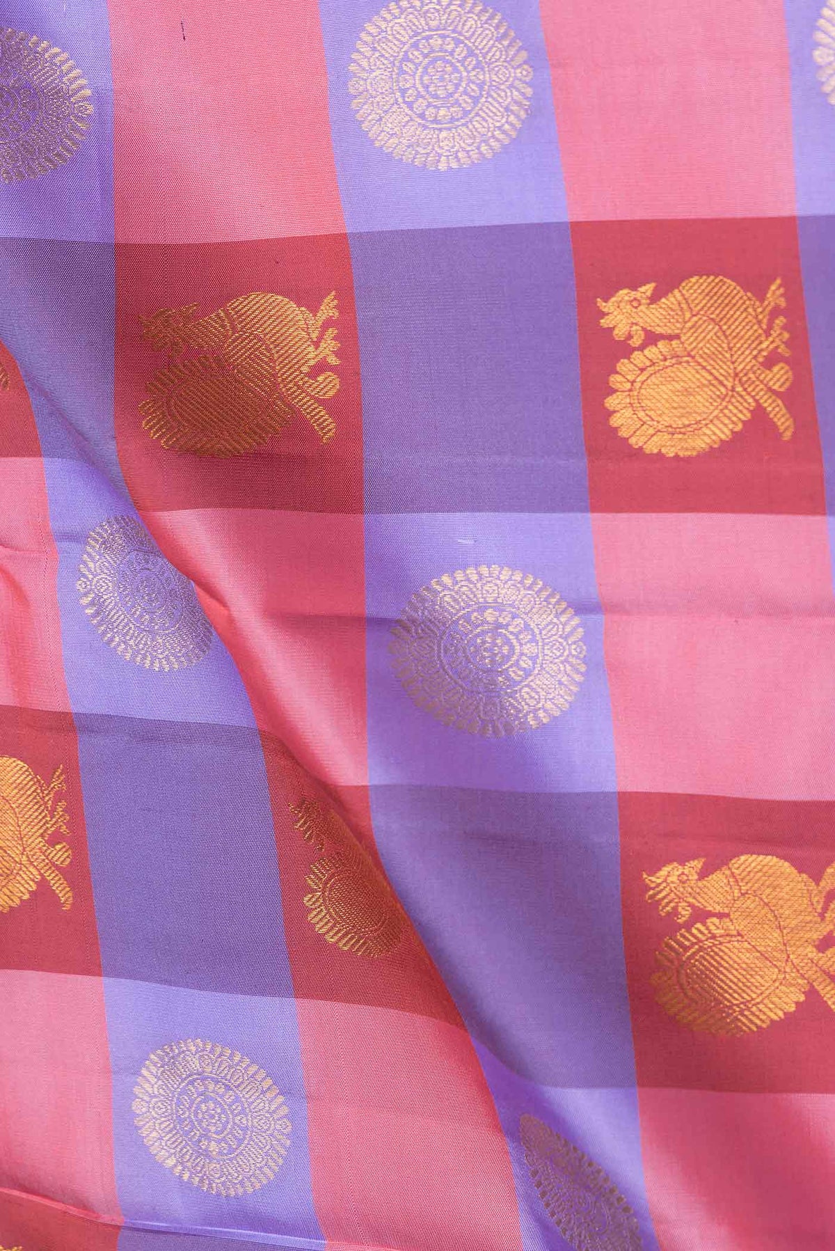 Close up of Lavender,Maroon and Pink Color Kanchipuram Saree with Checked design on the body and Zari Border.  displaying folds
