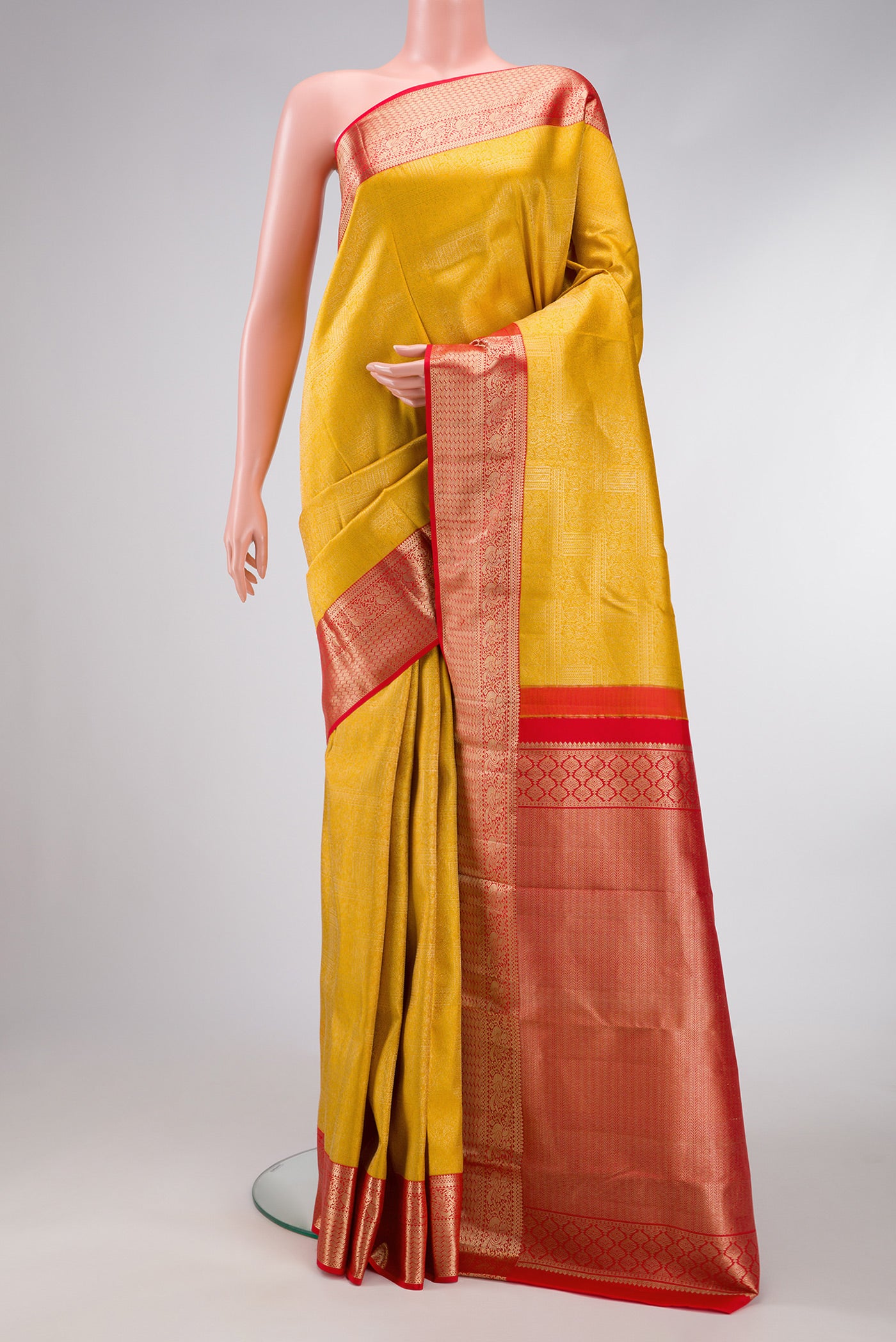 Mustard Dual Tone Kanjivaram Silk Saree with Zari Brocade on the body and Zari Border.  displayed on a mannequin