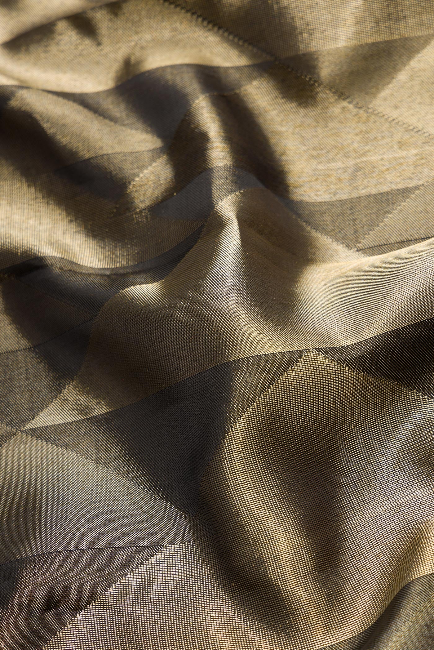 Close up of Black Dual Tone Kanjivaram Silk Saree with Zari Brocade on the body and Without Border.  displaying folds