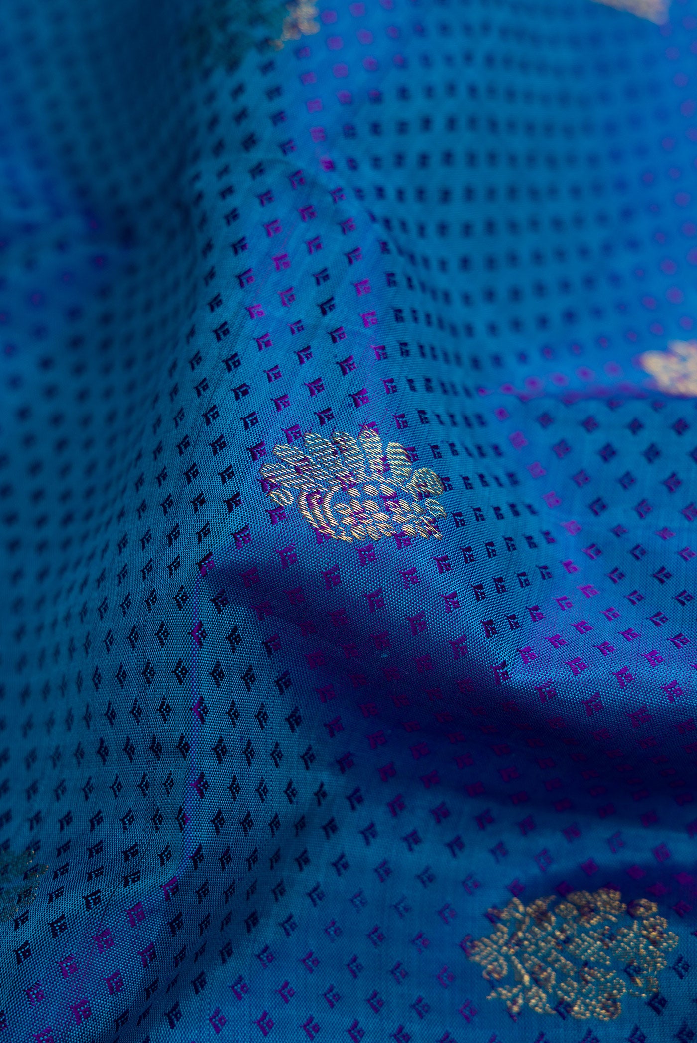 Close up of Peacock Blue Dual Tone Kanjivaram Silk Saree with Jacquard With Zari Butta on the body and Zari Border.  displaying folds