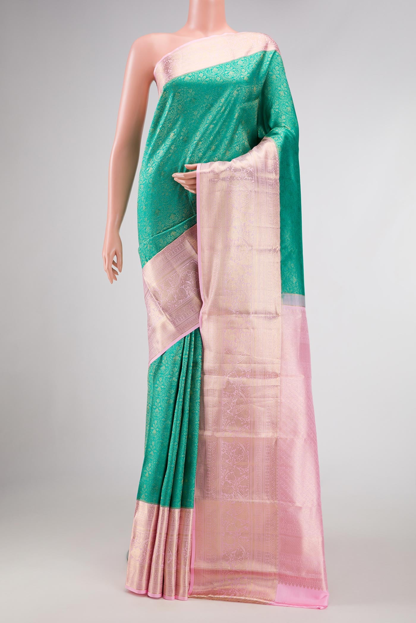 Green Dual Tone Kanjivaram Silk Saree with Zari Brocade on the body and Zari Border.  displayed on a mannequin