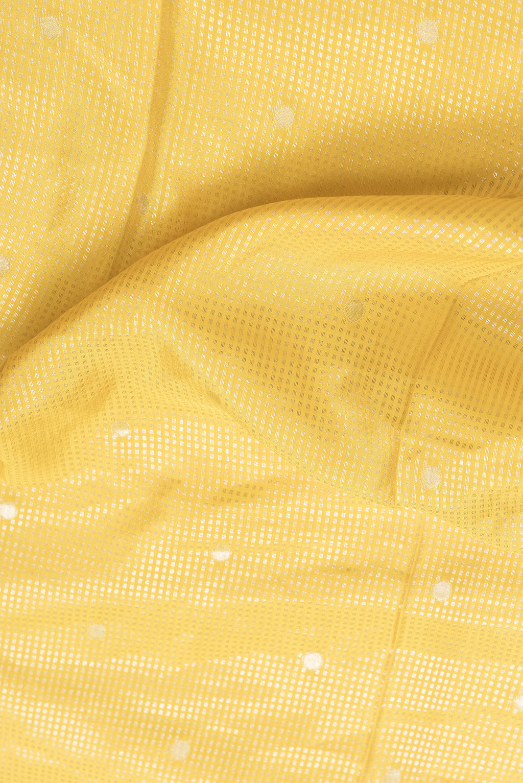 Close up of Yellow Dual Tone Mysore Silk Saree with Zari Brocade on the body and Fancy Border.  displaying folds